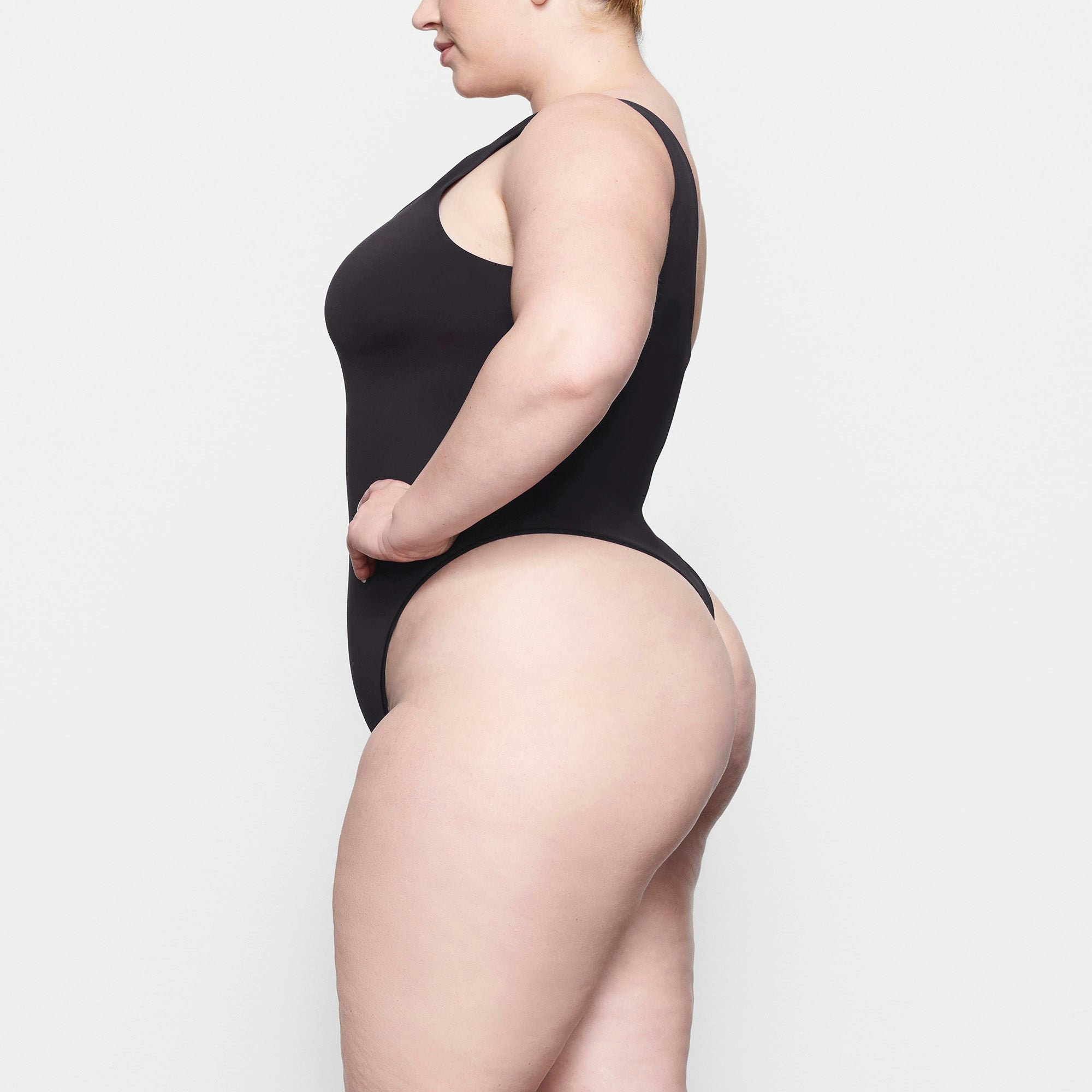 SOFT SMOOTHING THONG BODYSUIT WORN BY A MODEL IN SIDE VIEW