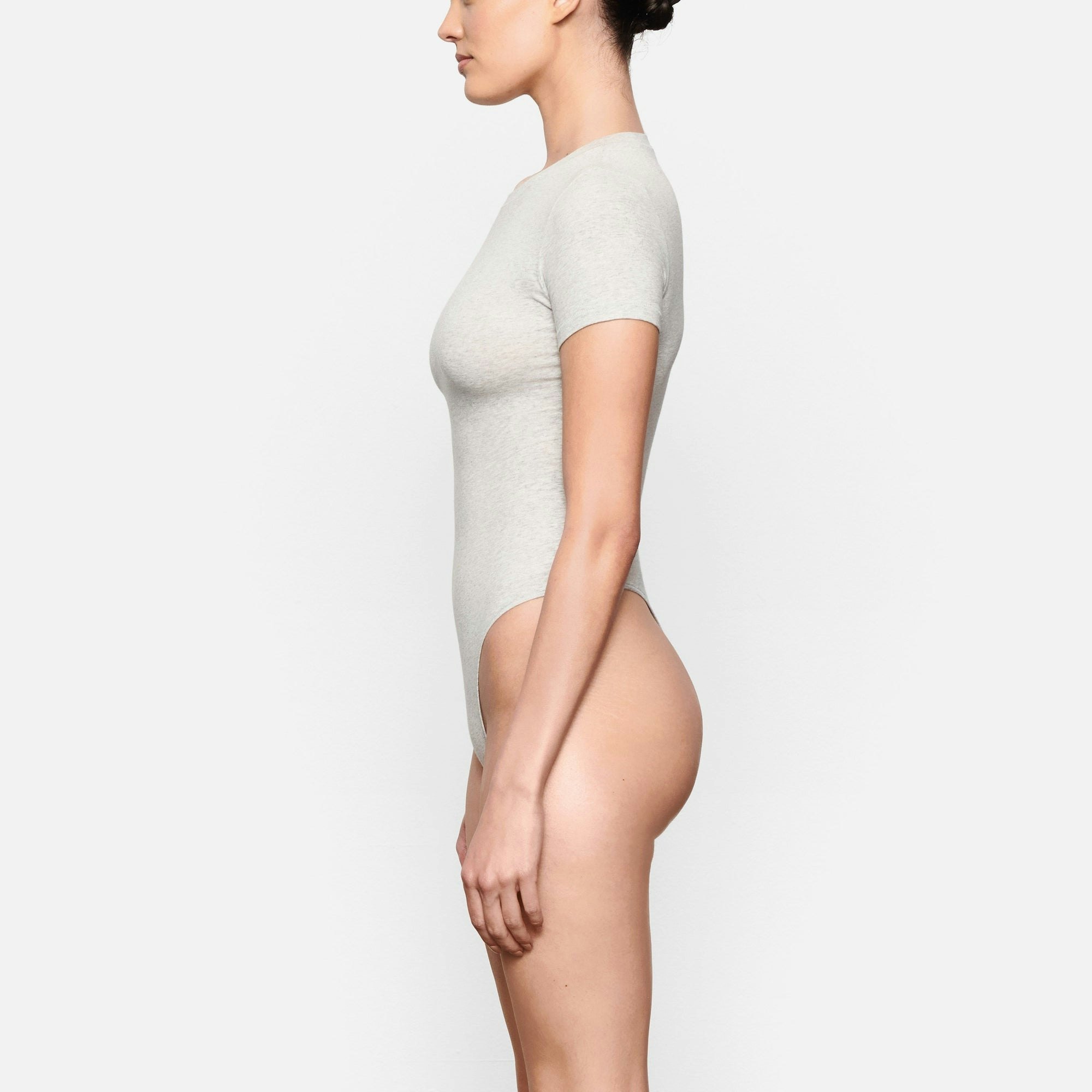 SIDE VIEW OF THE COTTON JERSEY T-SHIRT BODYSUIT ON A MODEL