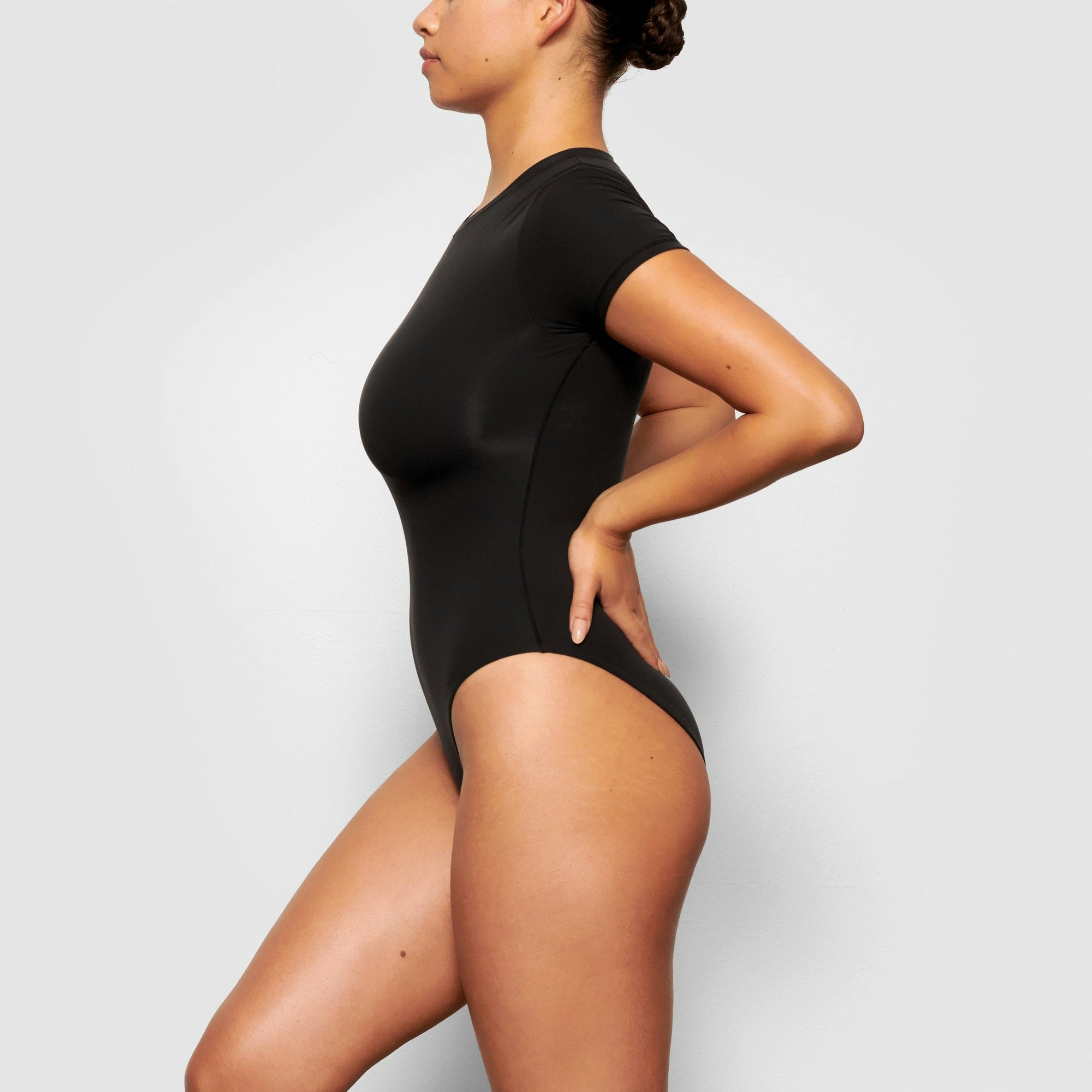 SIDE VIEW OF THE FITS EVERYBODY T-SHIRT BODYSUIT ON A MODEL