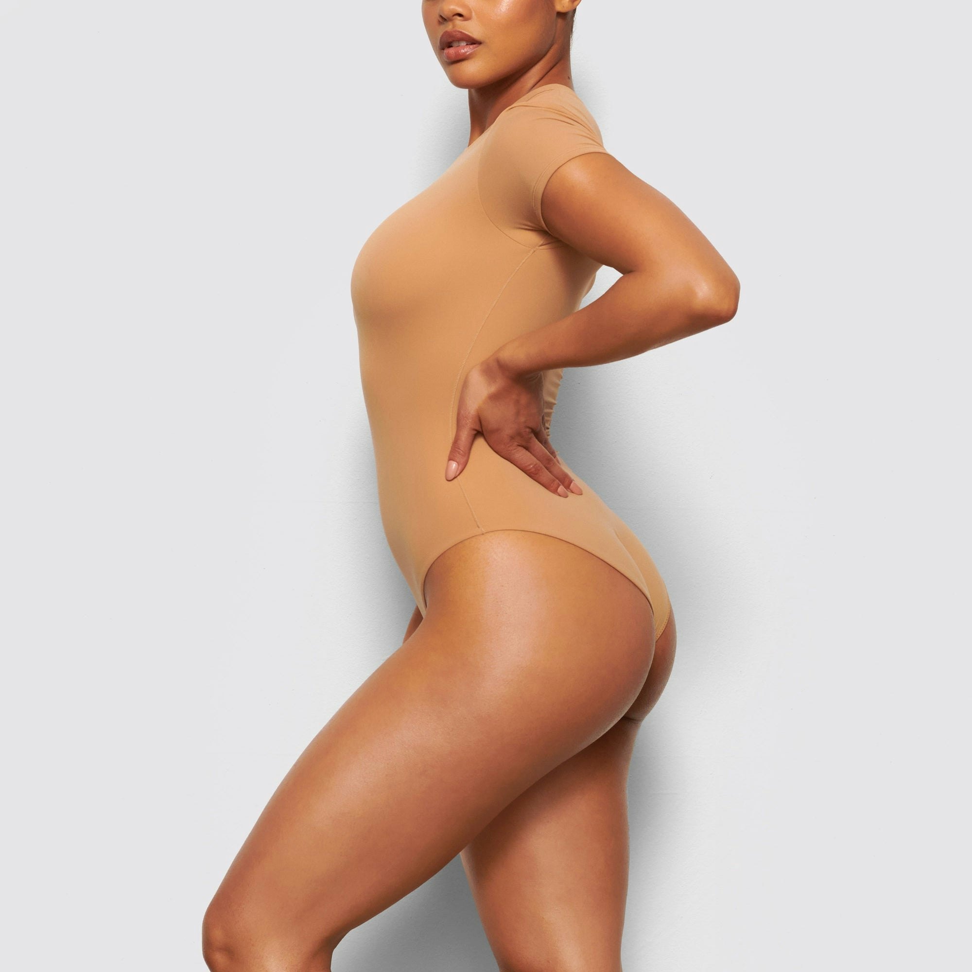 SIDE VIEW OF THE FITS EVERYBODY T-SHIRT BODYSUIT ON A MODEL