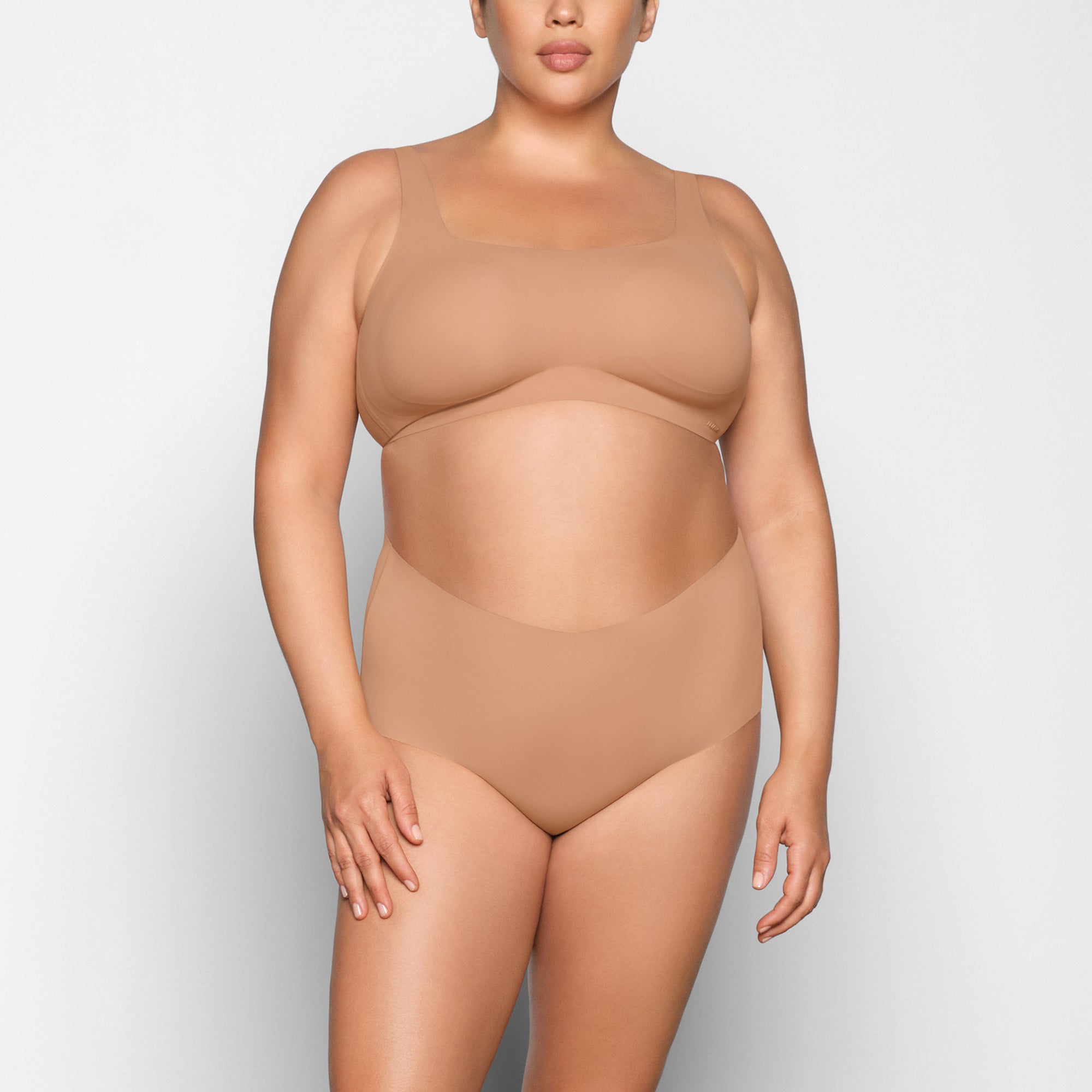 NAKED SCOOP BRA WORN BY A MODEL IN FRONT VIEW 