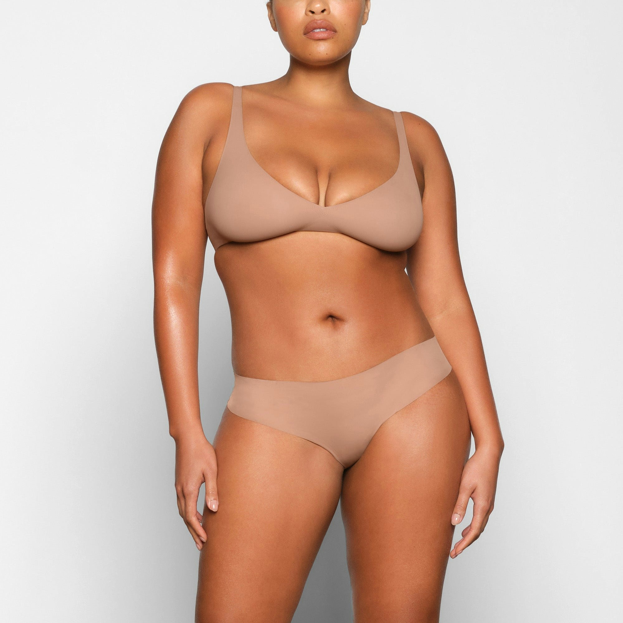 NAKED PLUNGE BRA WORN BY A MODEL IN FRONT VIEW | SEE: M, L, XL