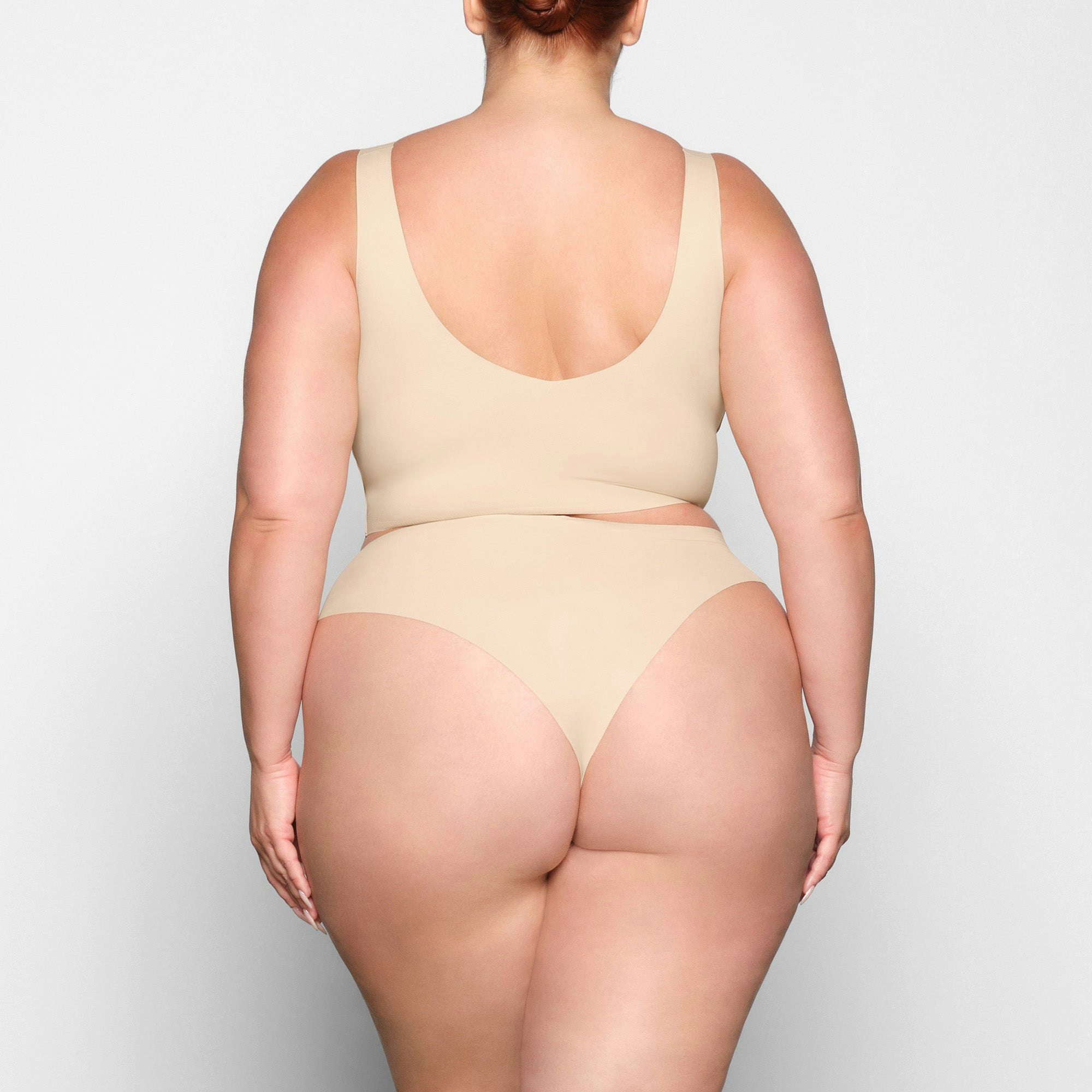 NAKED PLUNGE LONGLINE BRA ON A MODEL BACK VIEW