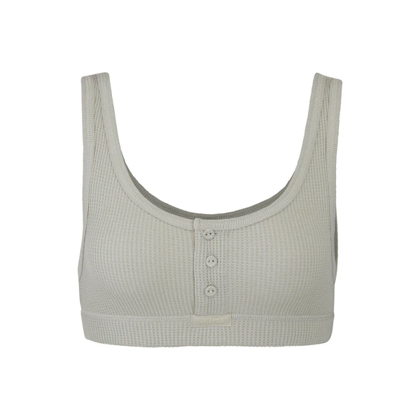 WAFFLE HENLEY BRA LAYS FLAT ON A WHITE BACKGROUND