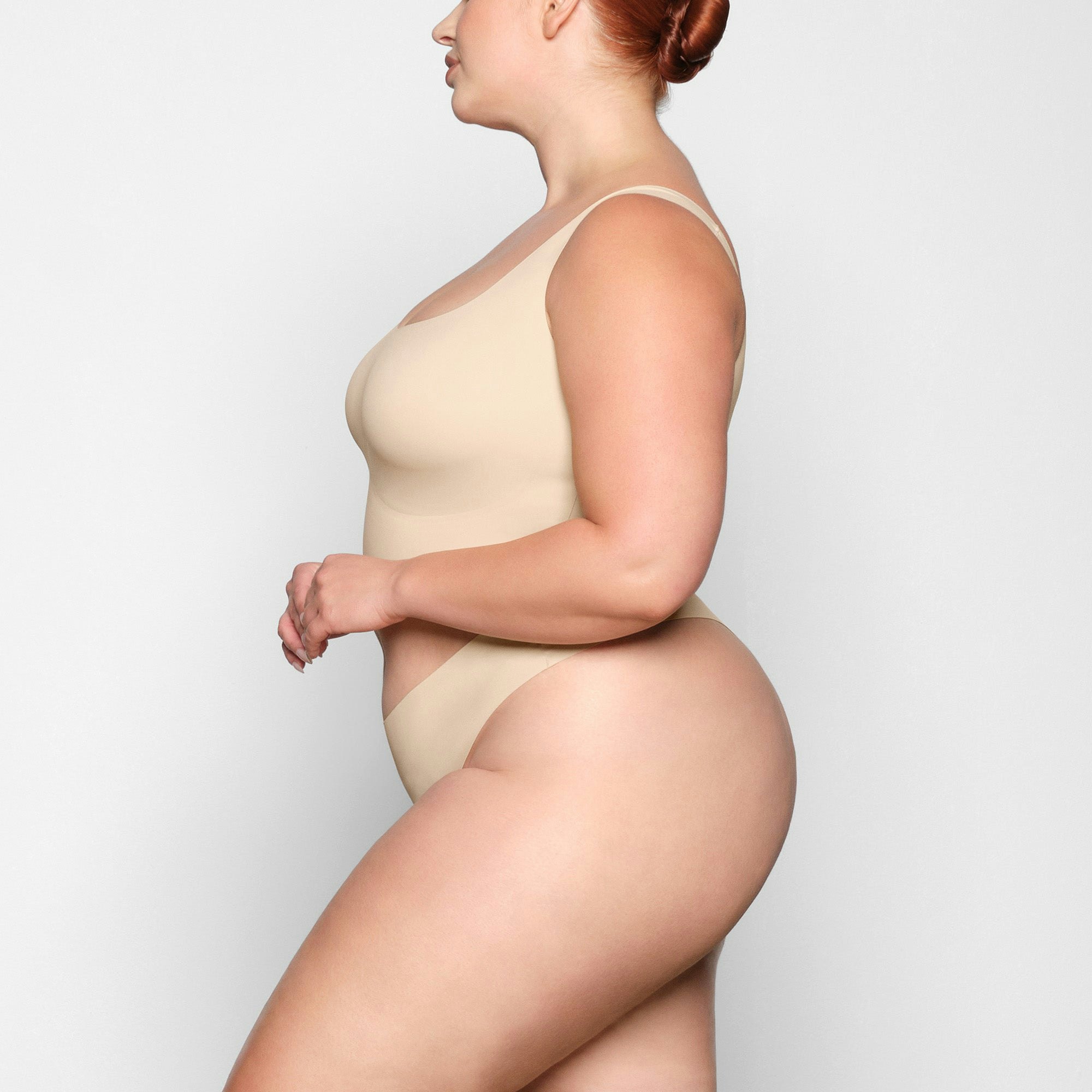 NAKED SCOOP LONGLINE BRA WORN BY A MODEL IN SIDE VIEW