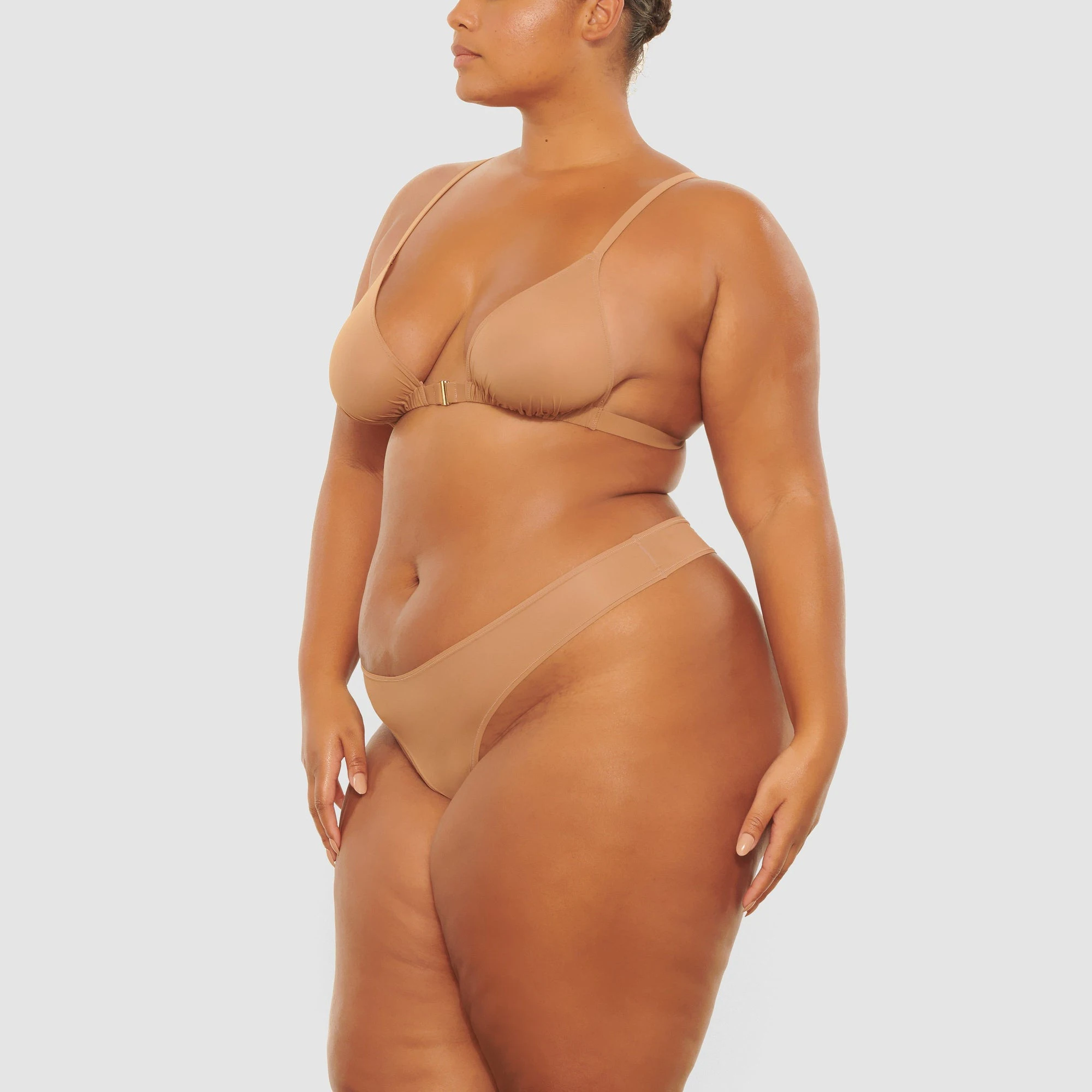 A MODEL STANDS SIDEWAYS SHOWING THE PROFILE OF THE JELLY SHEER TRIANGLE BRALETTE | SIENNA