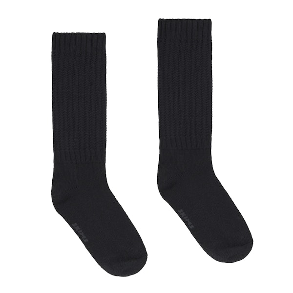 SLOUCH SOCK | SOOT (SLOUCH SOCKS) LAYS FLAT ON A WHITE BACKGROUND | FLT