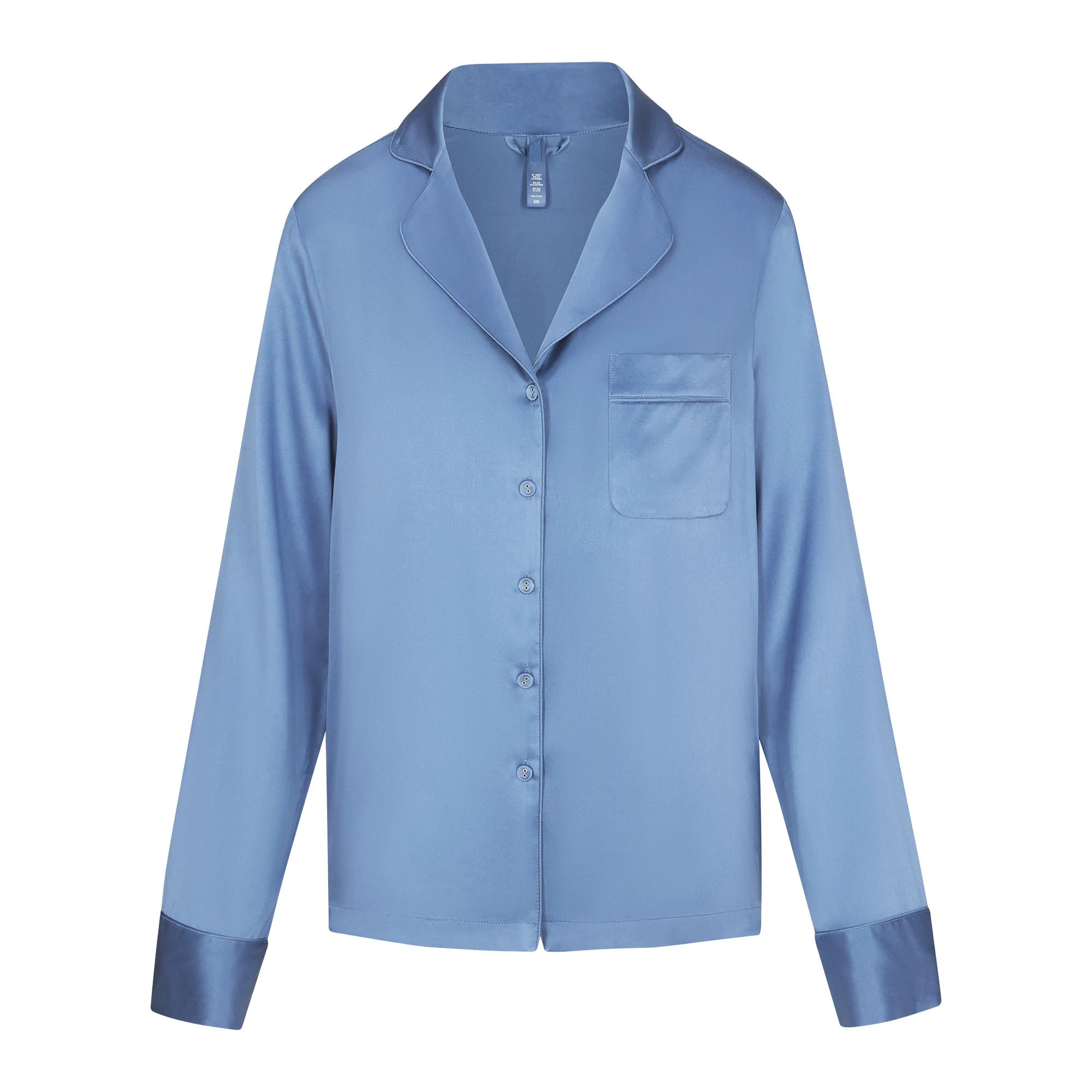 SILK BUTTON UP SHIRT LAYS FLAT ON A WHITE BACKGROUND