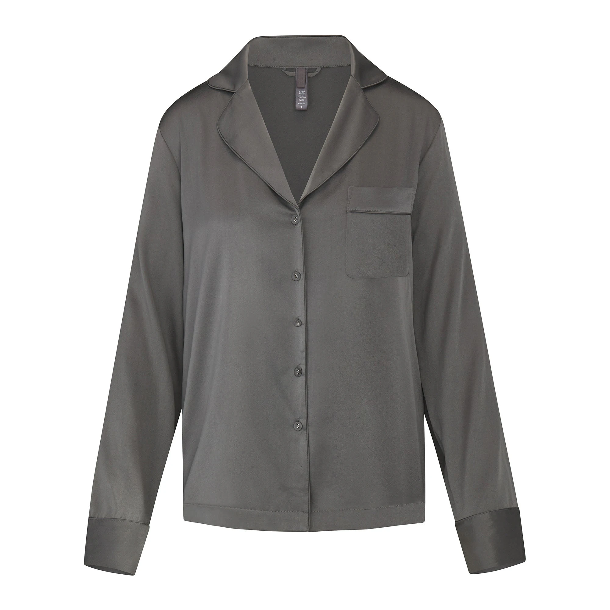 SILK BUTTON UP SHIRT LAYS FLAT ON A WHITE BACKGROUND