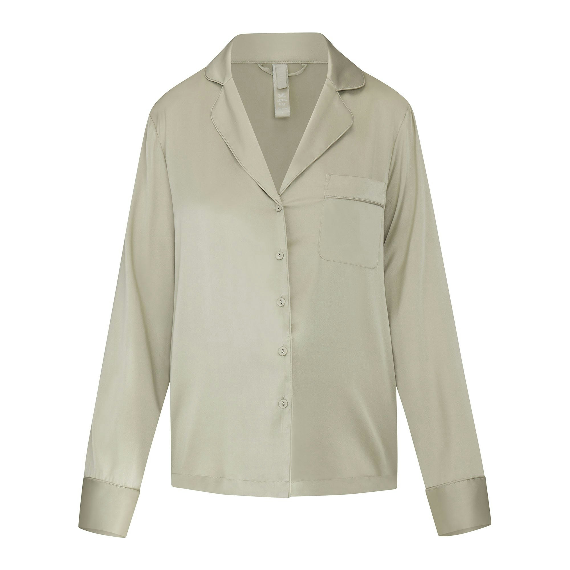 SILK BUTTON UP SHIRT LAYS FLAT ON A WHITE BACKGROUND