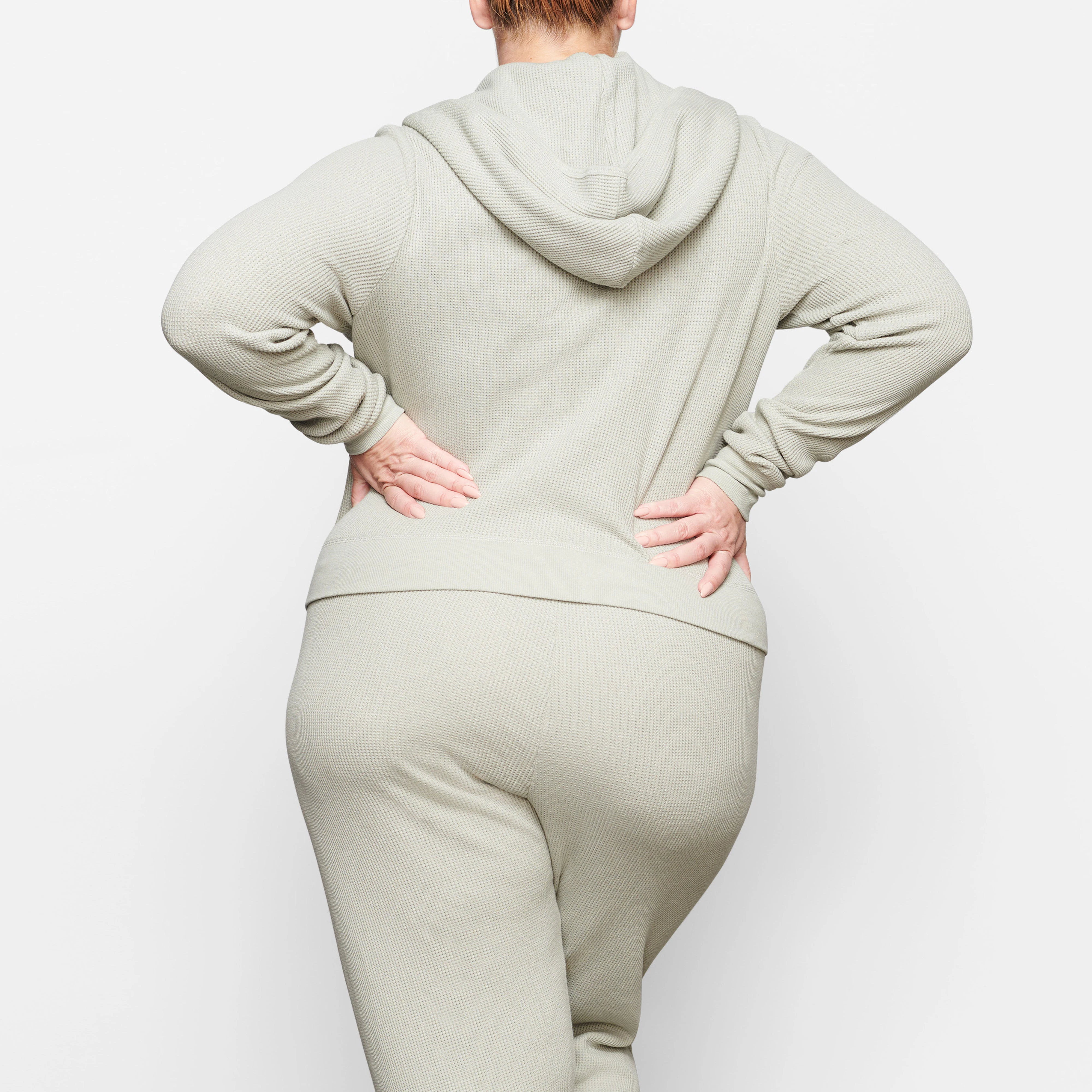 A MODEL WEARS THE WAFFLE HOODIE