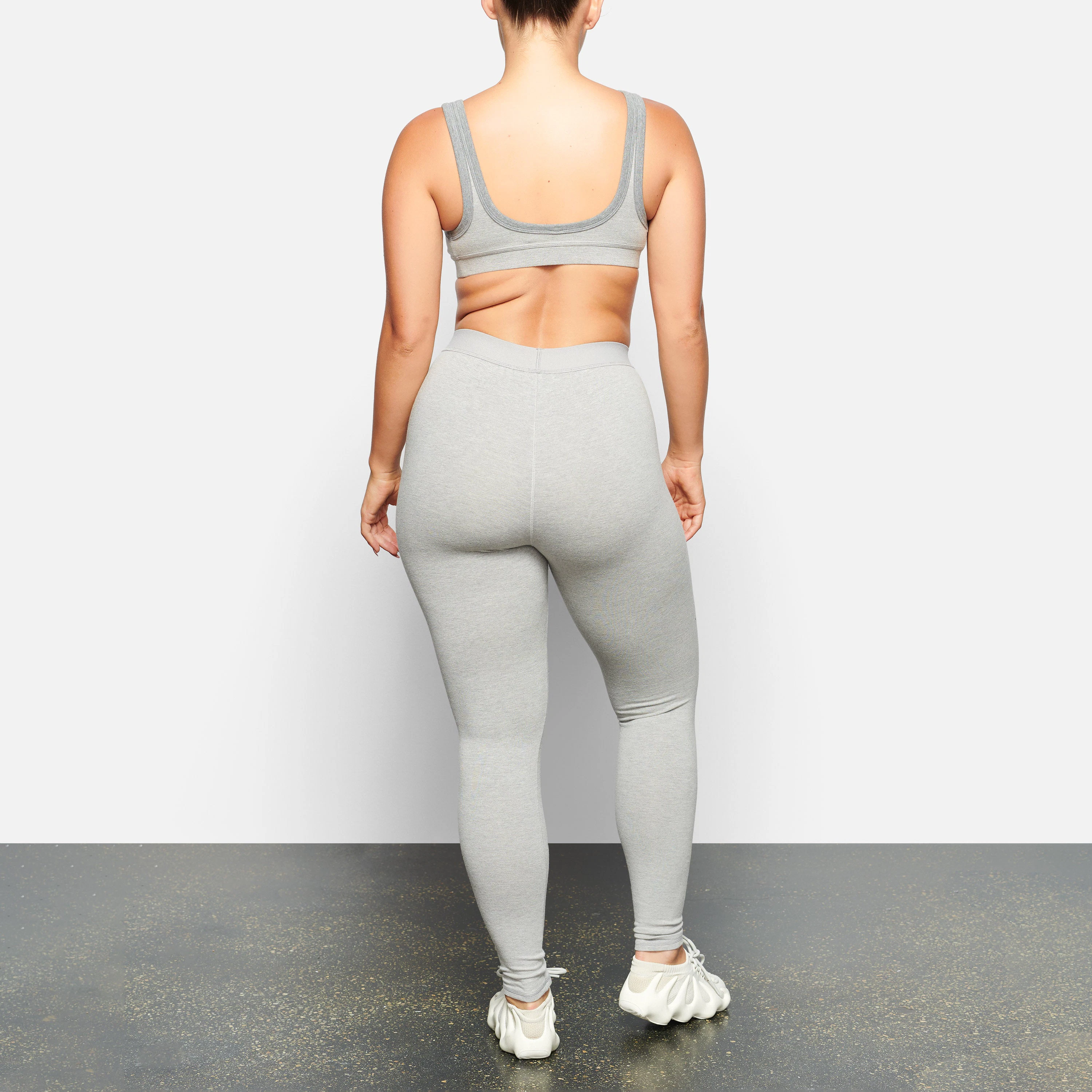 BACK VIEW OF THE OUTDOOR BASICS SEAMED LEGGING ON A MODEL