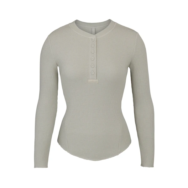 WAFFLE LONG SLEEVE HENLEY LAYS FLAT ON A WHITE BACKGROUND