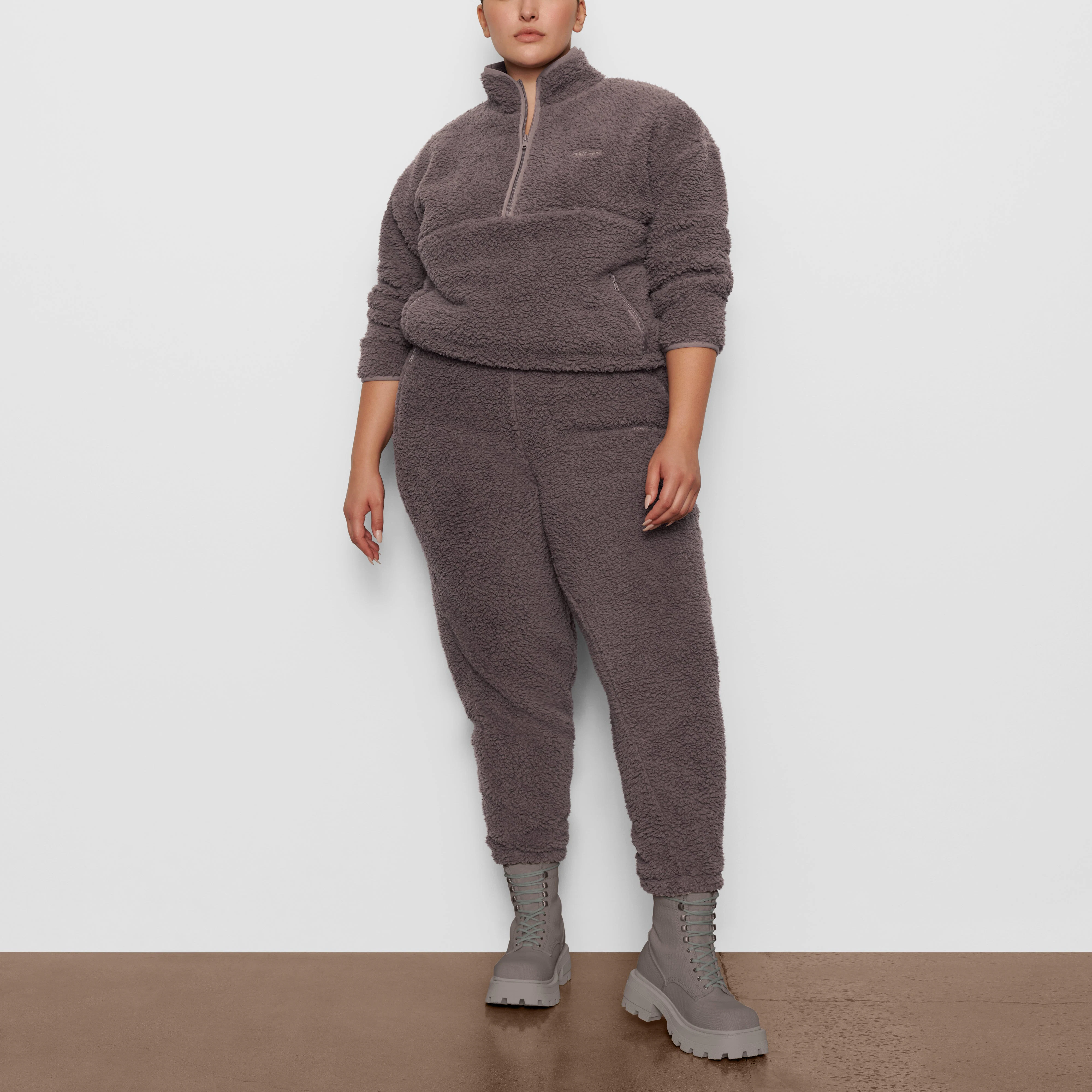 A MODEL STANDS FACING FORWARD WEARING THE SKIMS TEDDY PULLOVER IN AMETHYST | SEE: 2X, 3X, 4X