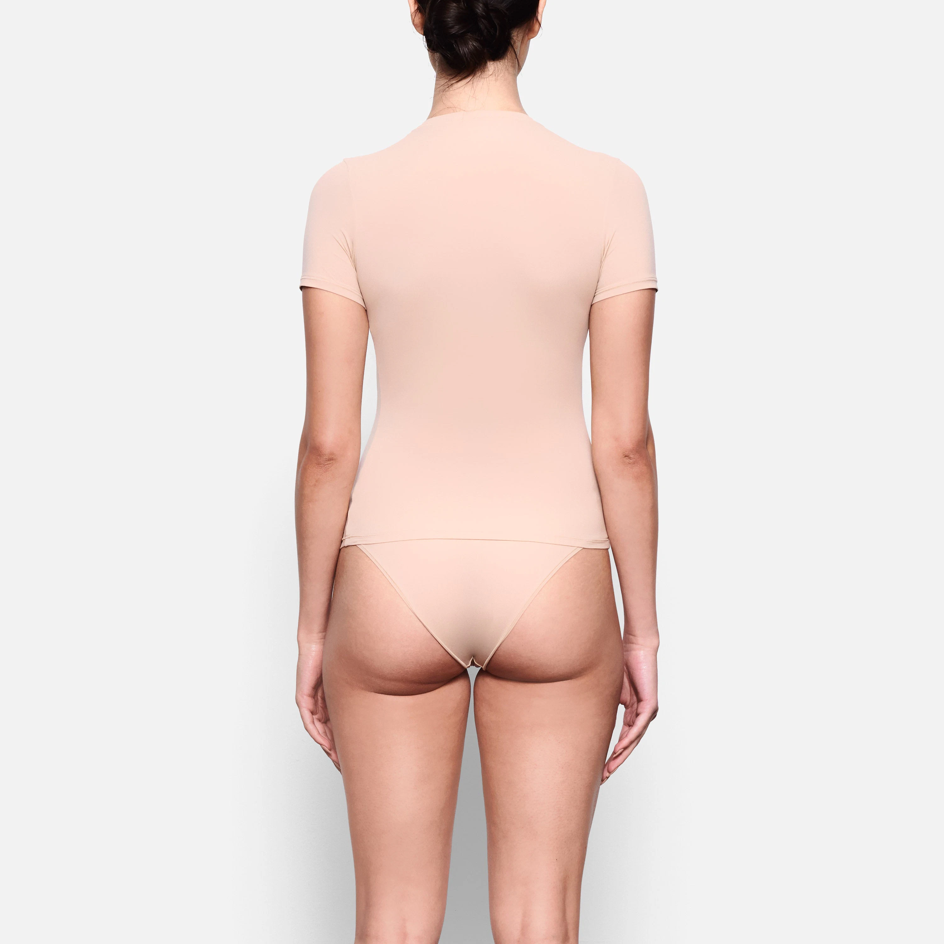 BACK VIEW OF THE FITS EVERYBODY SHORT SLEEVE T-SHIRT ON A MODEL