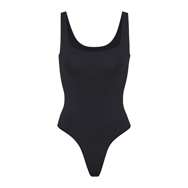 SOFT SMOOTHING SEAMLESS THONG BODYSUIT | ONYX (BODYSUITS) LAYS FLAT ON A WHITE BACKGROUND | FLT