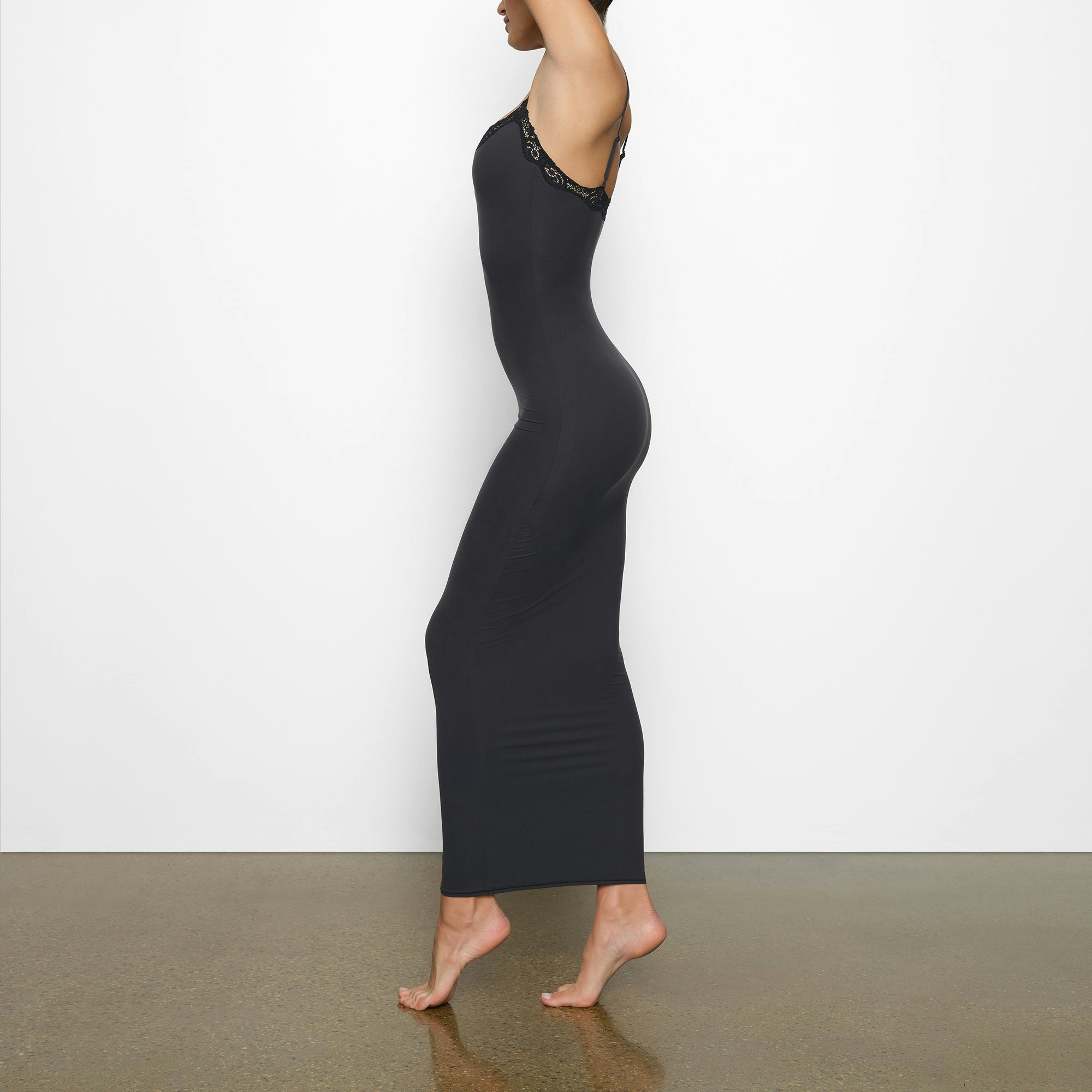 FITS EVERYBODY LACE LONG SLIP DRESS WORN BY A MODEL IN SIDE VIEW