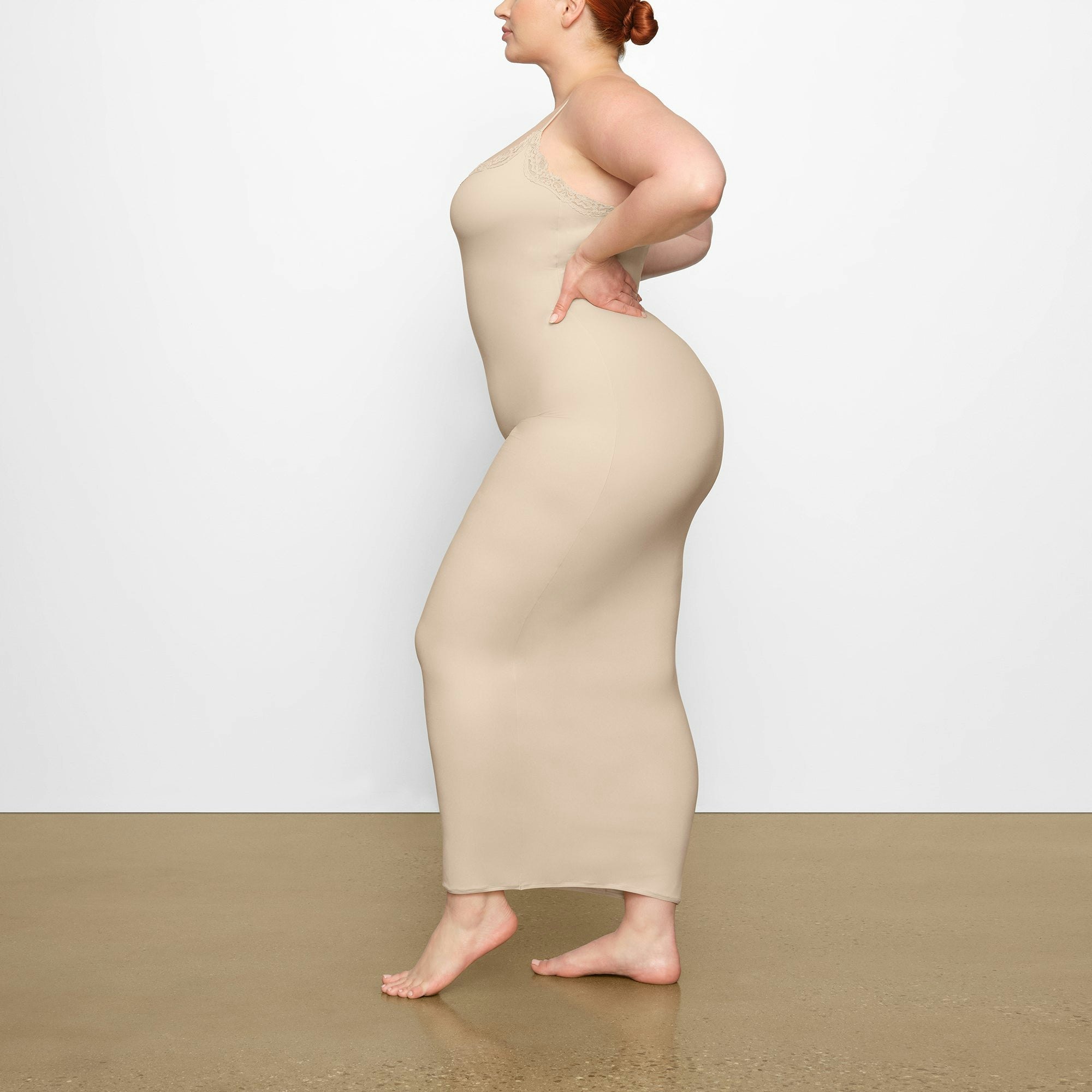 FITS EVERYBODY LACE LONG SLIP DRESS WORN BY A MODEL IN SIDE VIEW