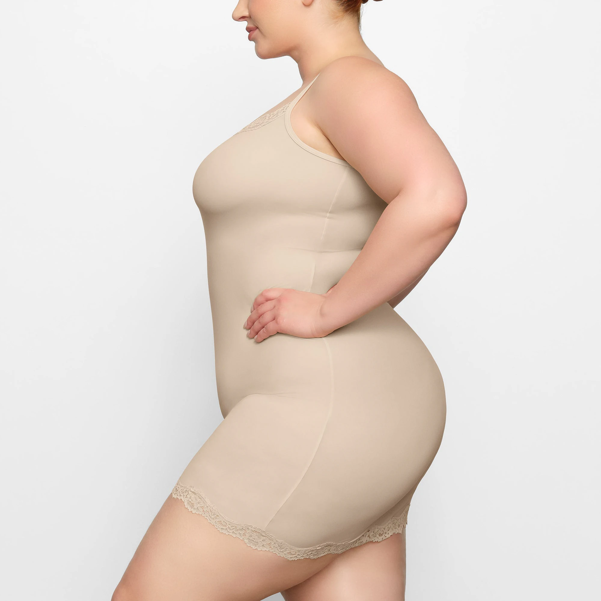 FITS EVERYBODY LACE SLIP DRESS WORN BY A MODEL IN SIDE VIEW