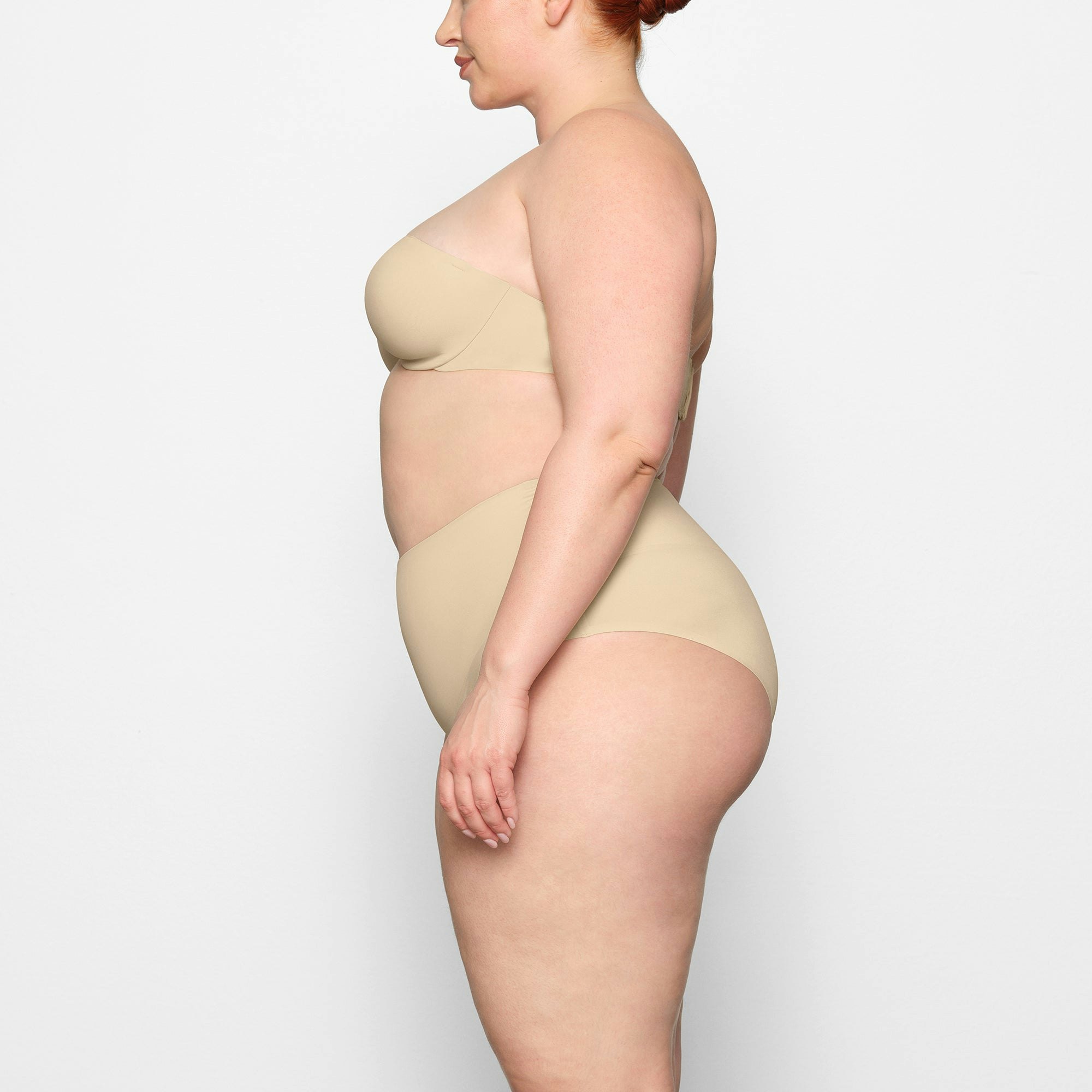 SMOOTHING HIGH WAIST BRIEF WORN BY A MODEL IN SIDE VIEW