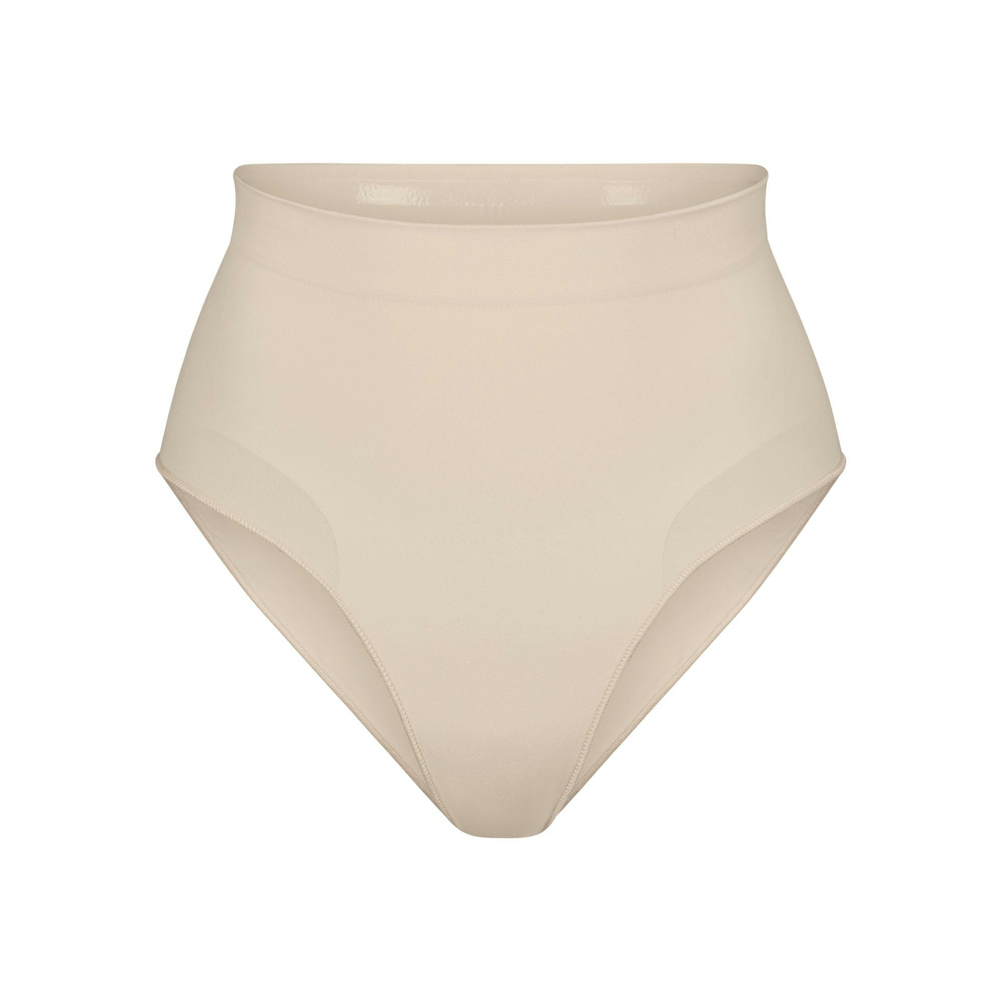 SEAMLESS SCULPT MID WAIST BRIEF | SAND (SHAPEWEAR BRIEFS, PANTIES) LAYS FLAT ON A WHITE BACKGROUND | FLT