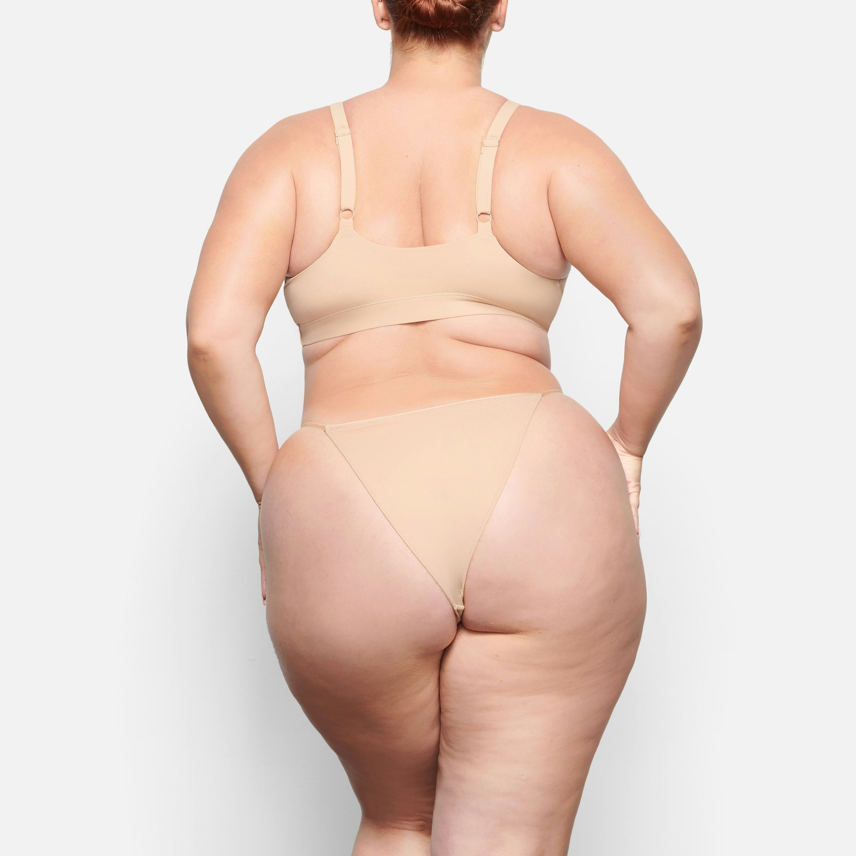 BACK VIEW OF THE FITS EVERYBODY CHEEKY STRING BIKINI ON A MODEL