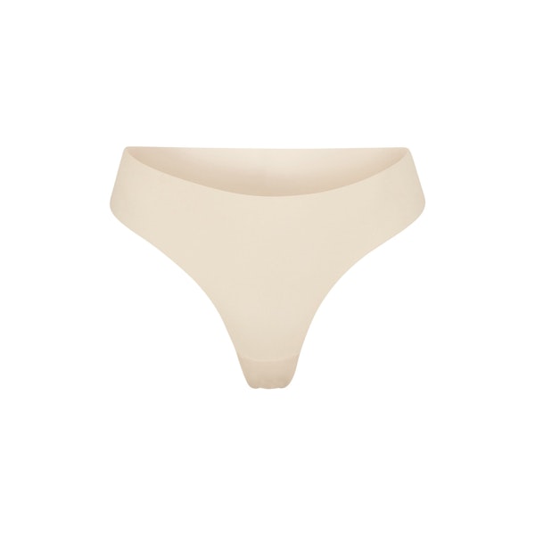 NAKED DIPPED THONG | SAND (THONGS, PANTIES) LAYS FLAT ON A WHITE BACKGROUND | FLT