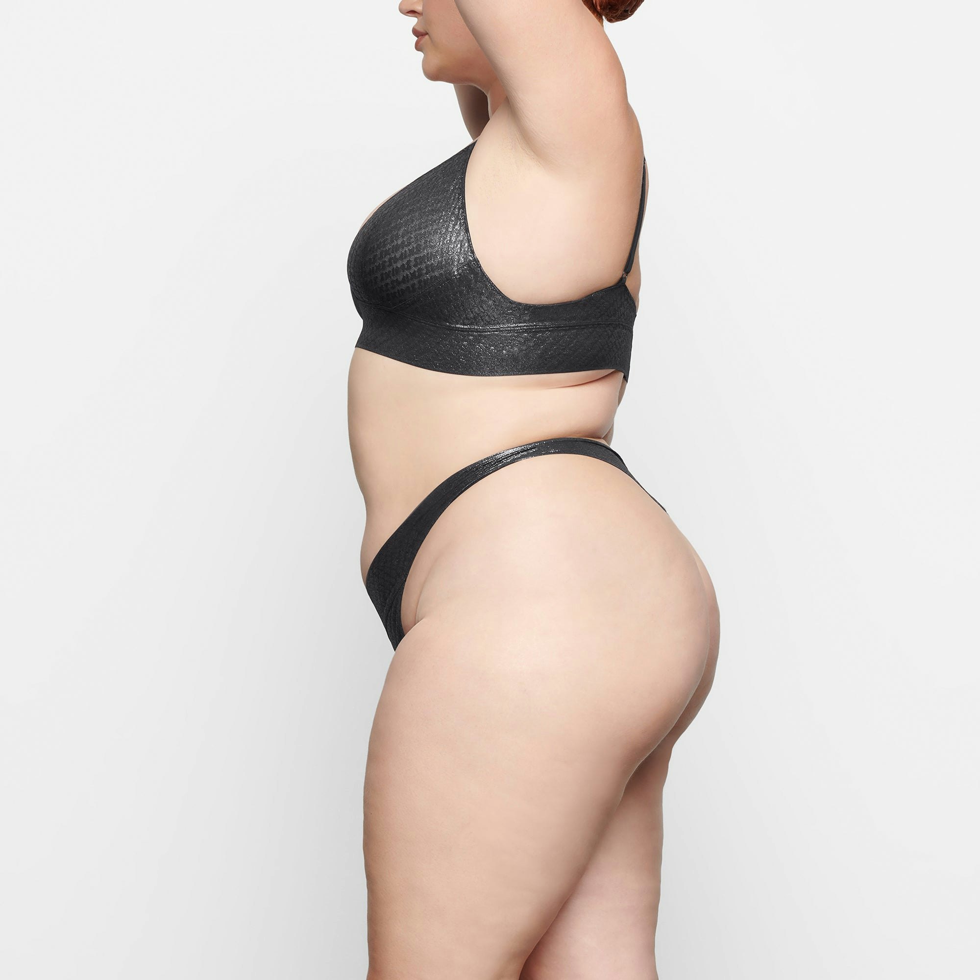 LOGO MESH FOIL TRIANGLE BRALETTE WORN BY A MODEL IN SIDE VIEW