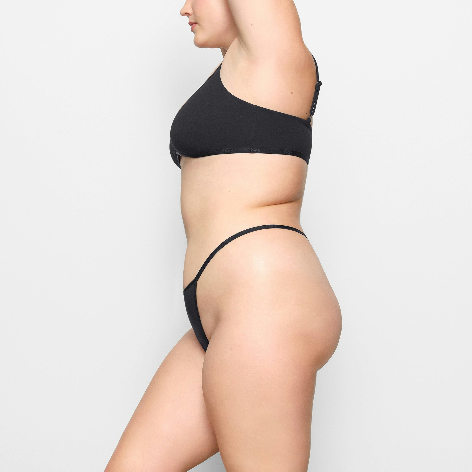 COTTON LOGO STRING THONG WORN BY A MODEL IN SIDE VIEW