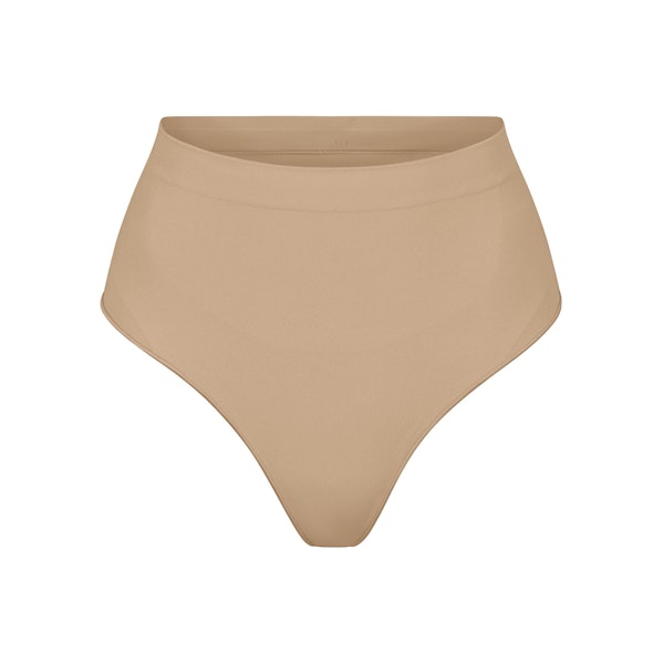 SEAMLESS SCULPT MID WAIST THONG | CLAY (SHAPEWEAR THONGS, PANTIES) LAYS FLAT ON A WHITE BACKGROUND | FLT