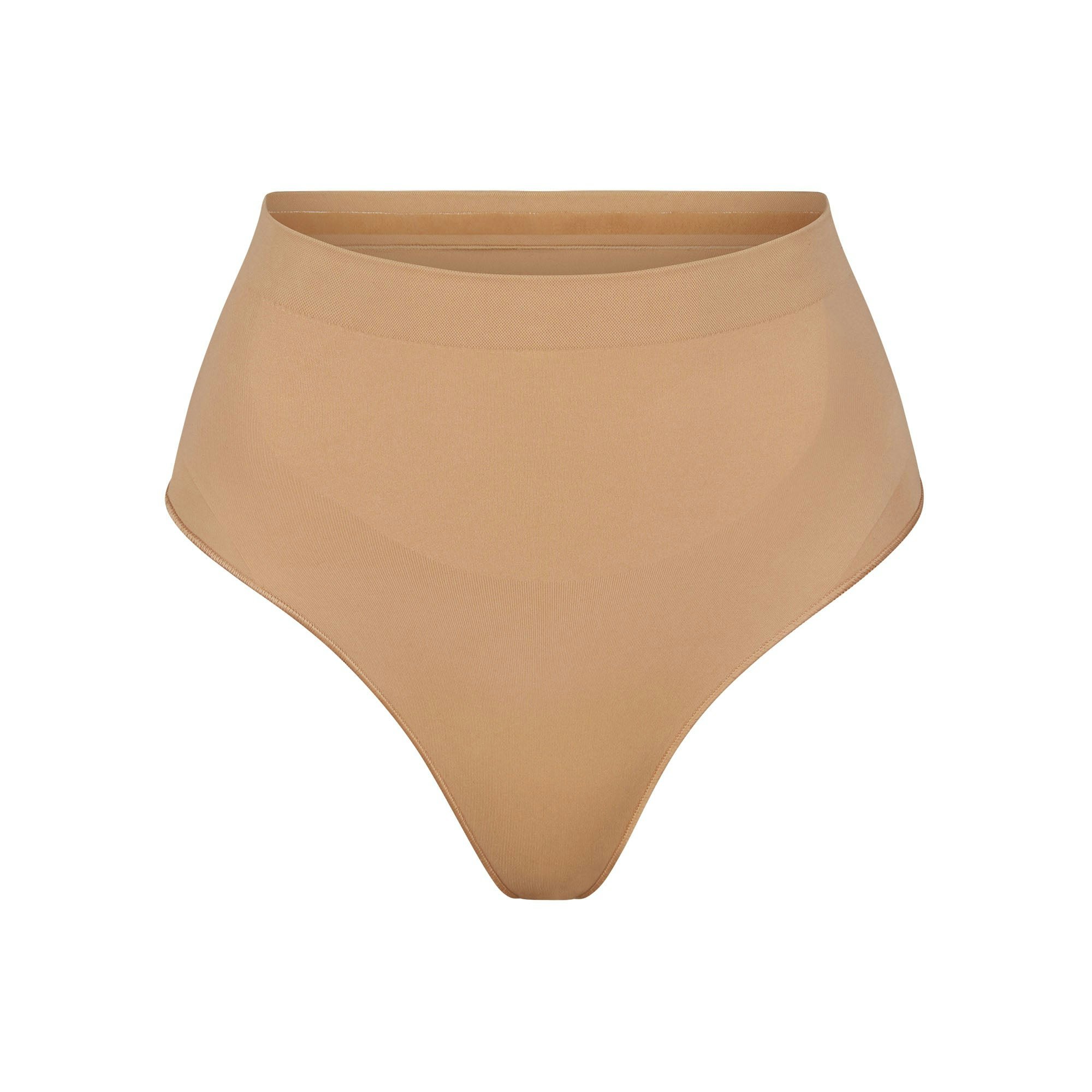 SEAMLESS SCULPT MID WAIST THONG | OCHRE (SHAPEWEAR THONGS, PANTIES) LAYS FLAT ON A WHITE BACKGROUND | FLT