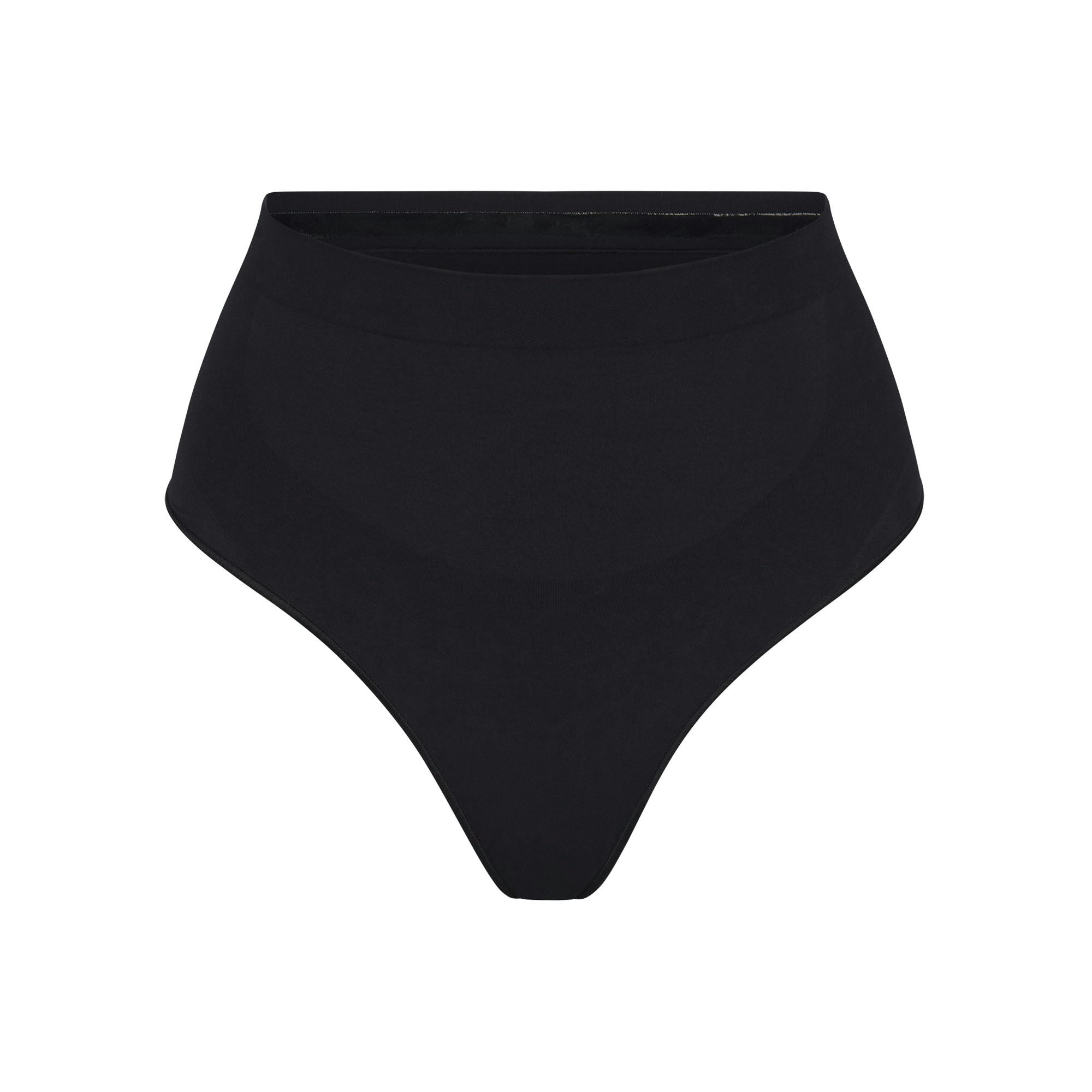 SEAMLESS SCULPT MID WAIST THONG | ONYX (SHAPEWEAR THONGS, PANTIES) LAYS FLAT ON A WHITE BACKGROUND | FLT
