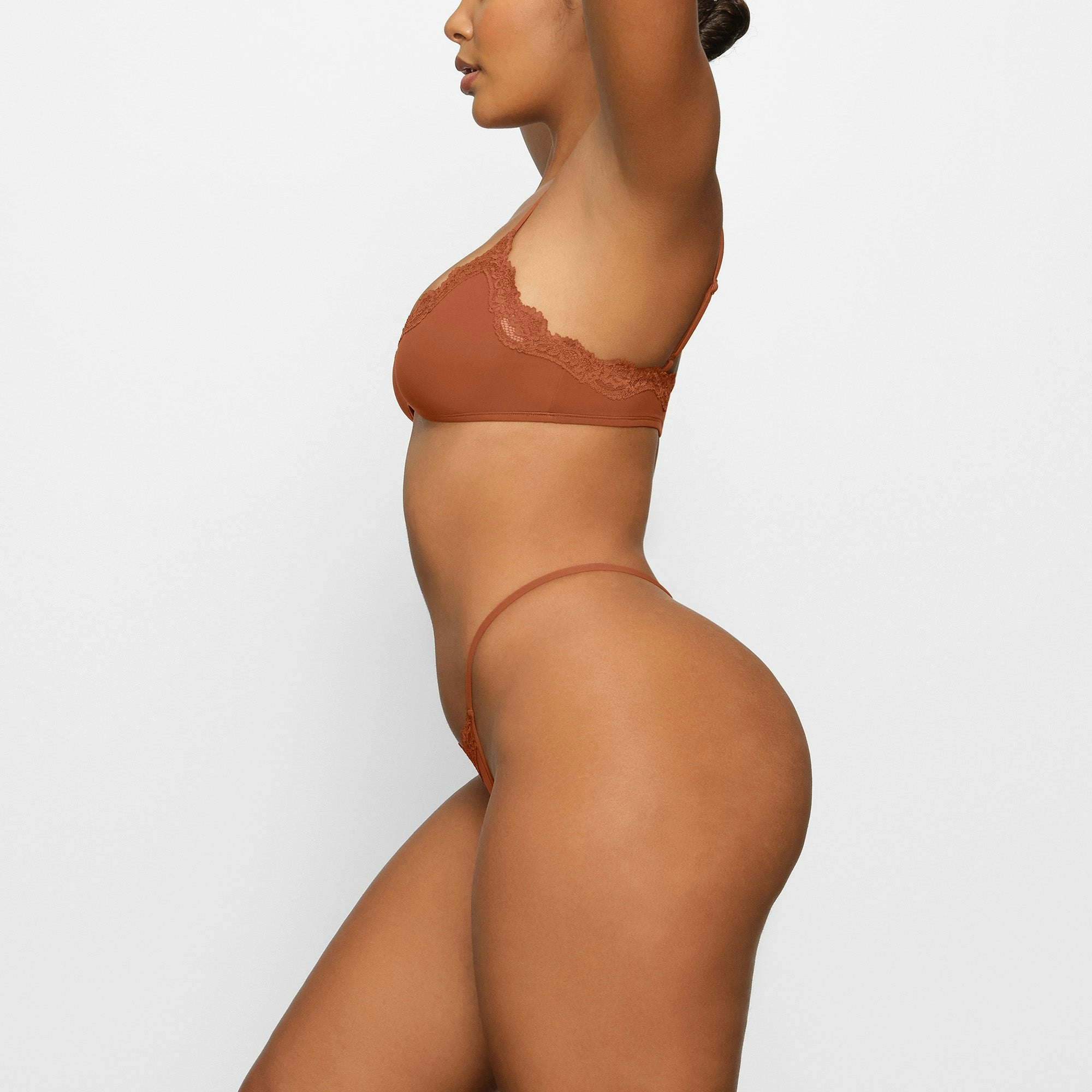 FITS EVERYBODY LACE STRING THONG WORN BY A MODEL IN SIDE VIEW