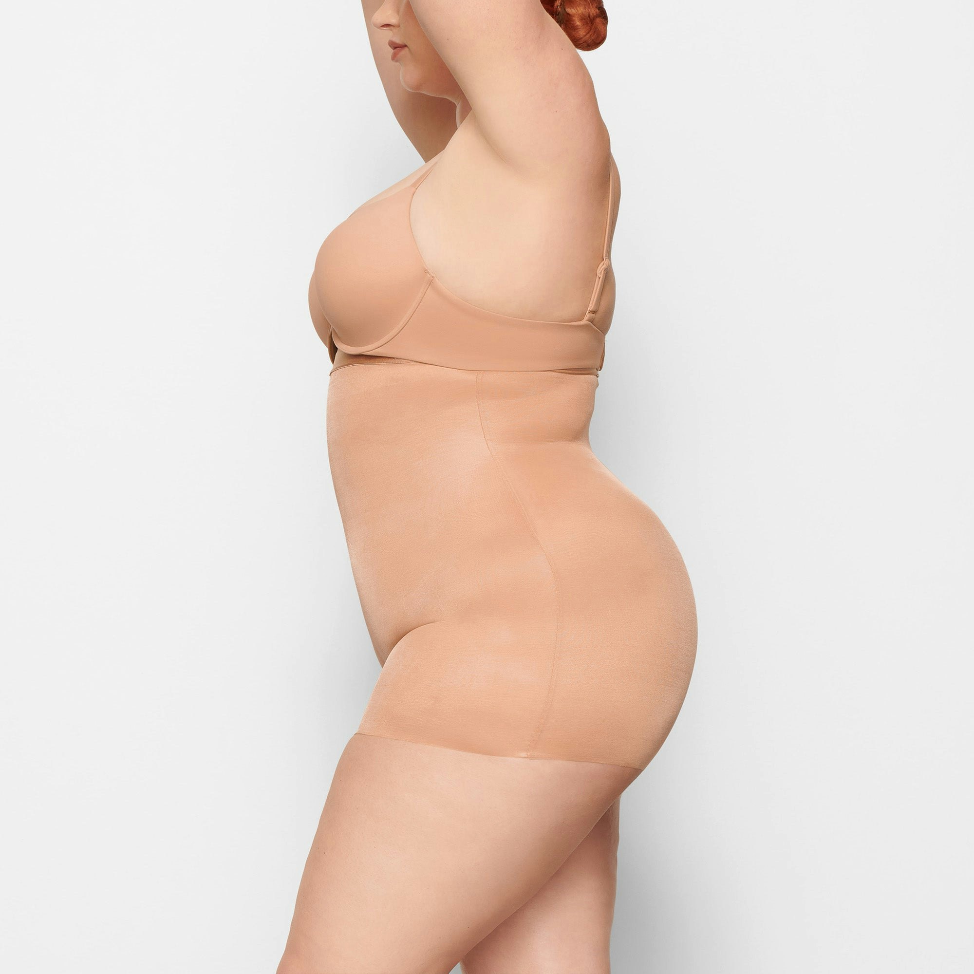 BARELY THERE HIGH WAIST SHORTIE WORN BY A MODEL IN SIDE VIEW