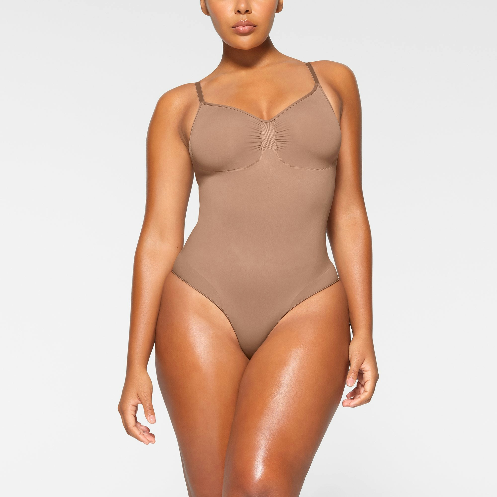 SEAMLESS SCULPT BRIEF BODYSUIT WORN BY A MODEL IN FRONT VIEW | SEE: M, L, XL