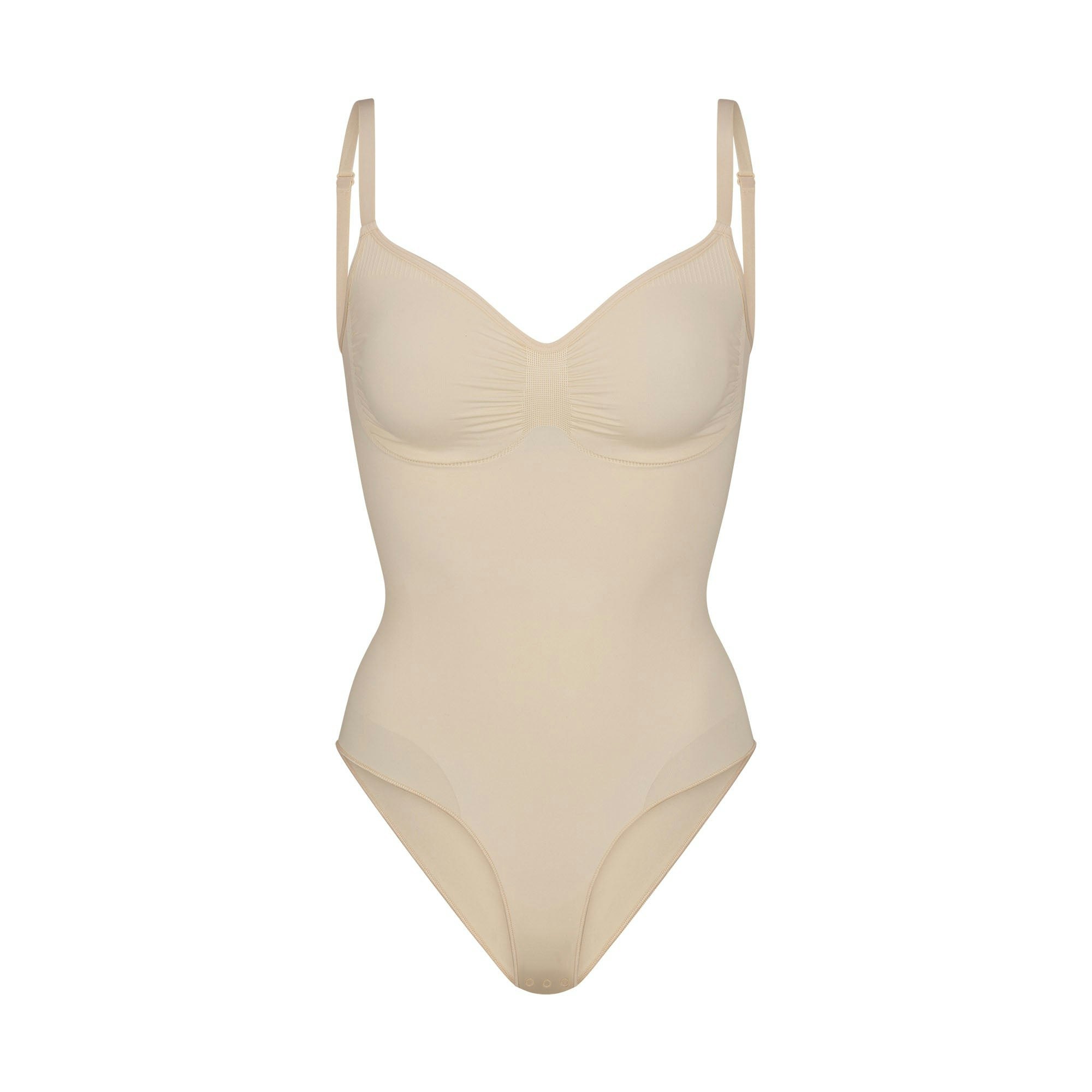 SEAMLESS SCULPT BRIEF BODYSUIT | SAND (SHAPEWEAR BODYSUITS) LAYS FLAT ON A WHITE BACKGROUND | FLT