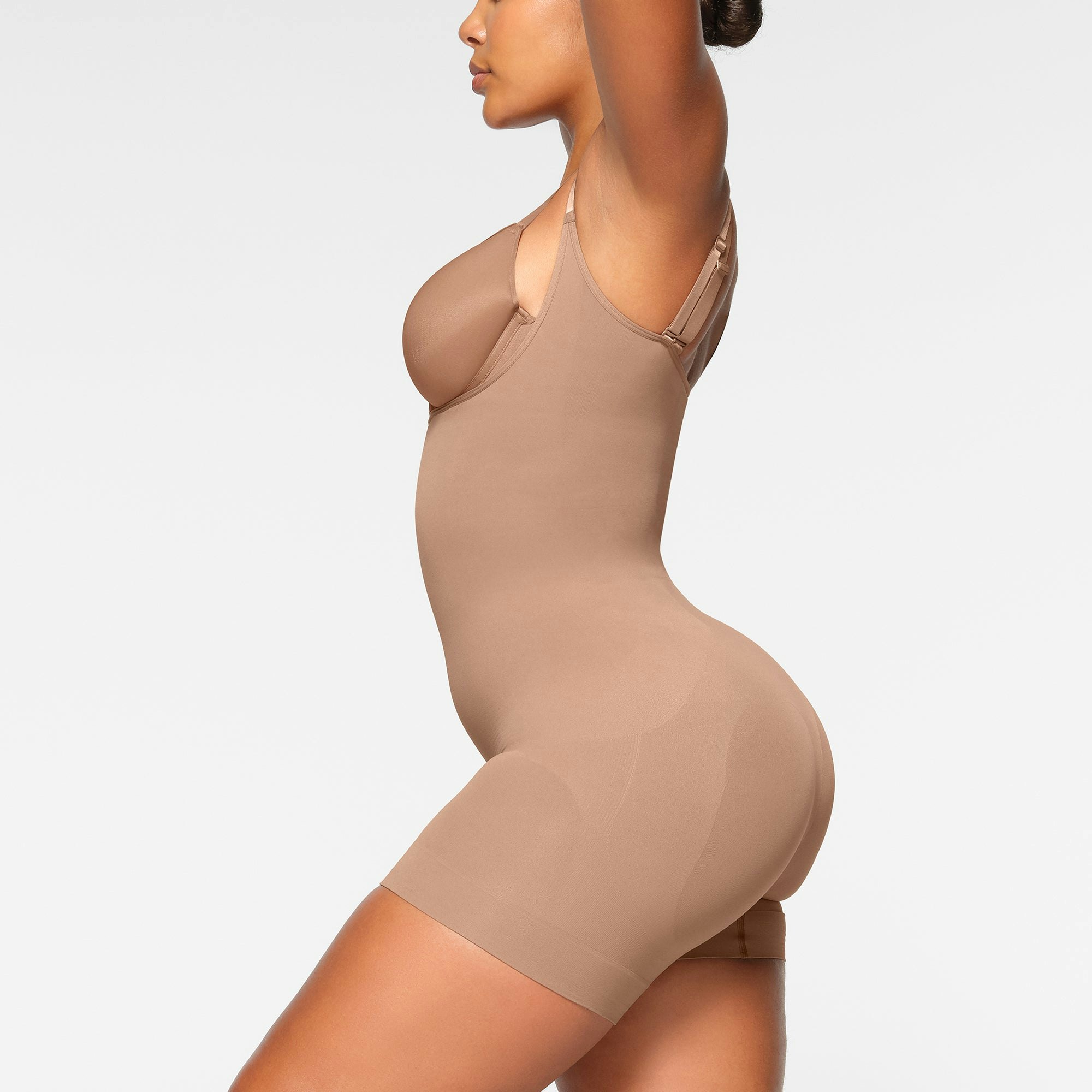 SEAMLESS SCULPT OPEN BUST SHORTIE BODYSUIT ON A MODEL BACK VIEW