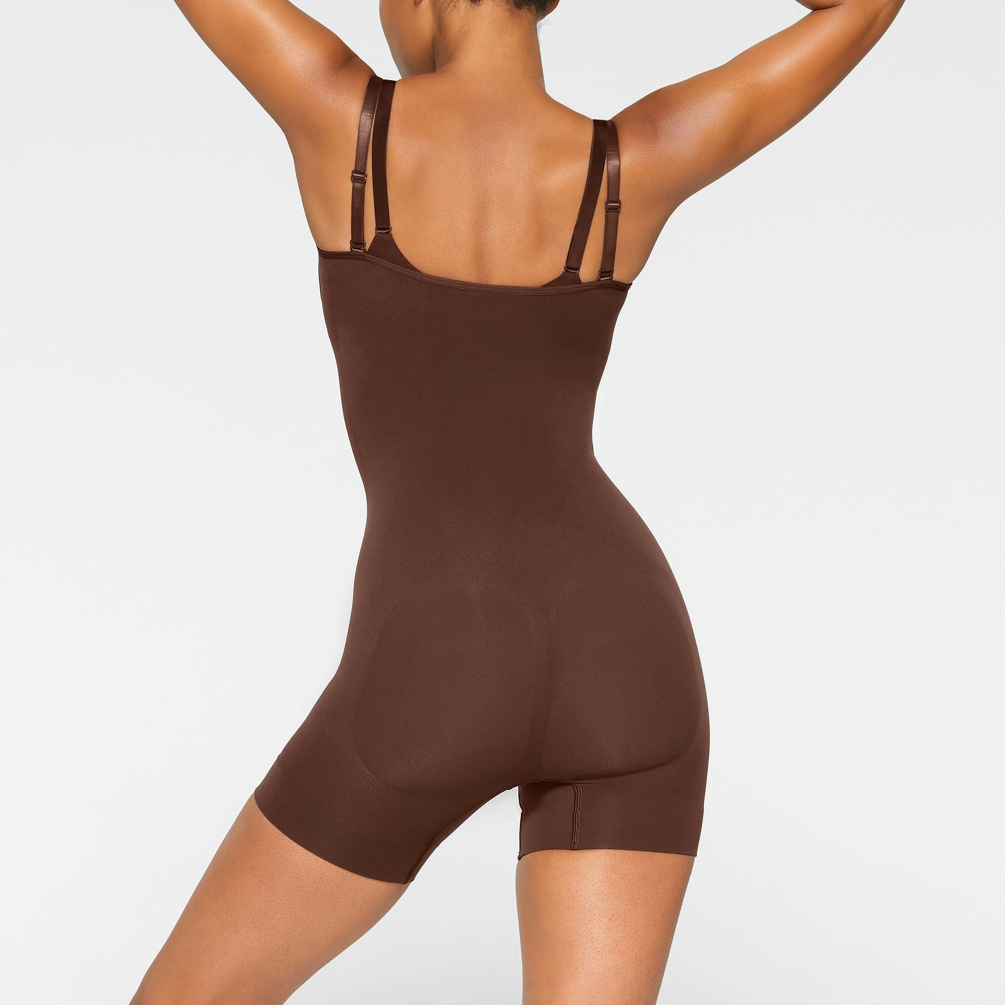 SEAMLESS SCULPT OPEN BUST SHORTIE BODYSUIT ON A MODEL BACK VIEW