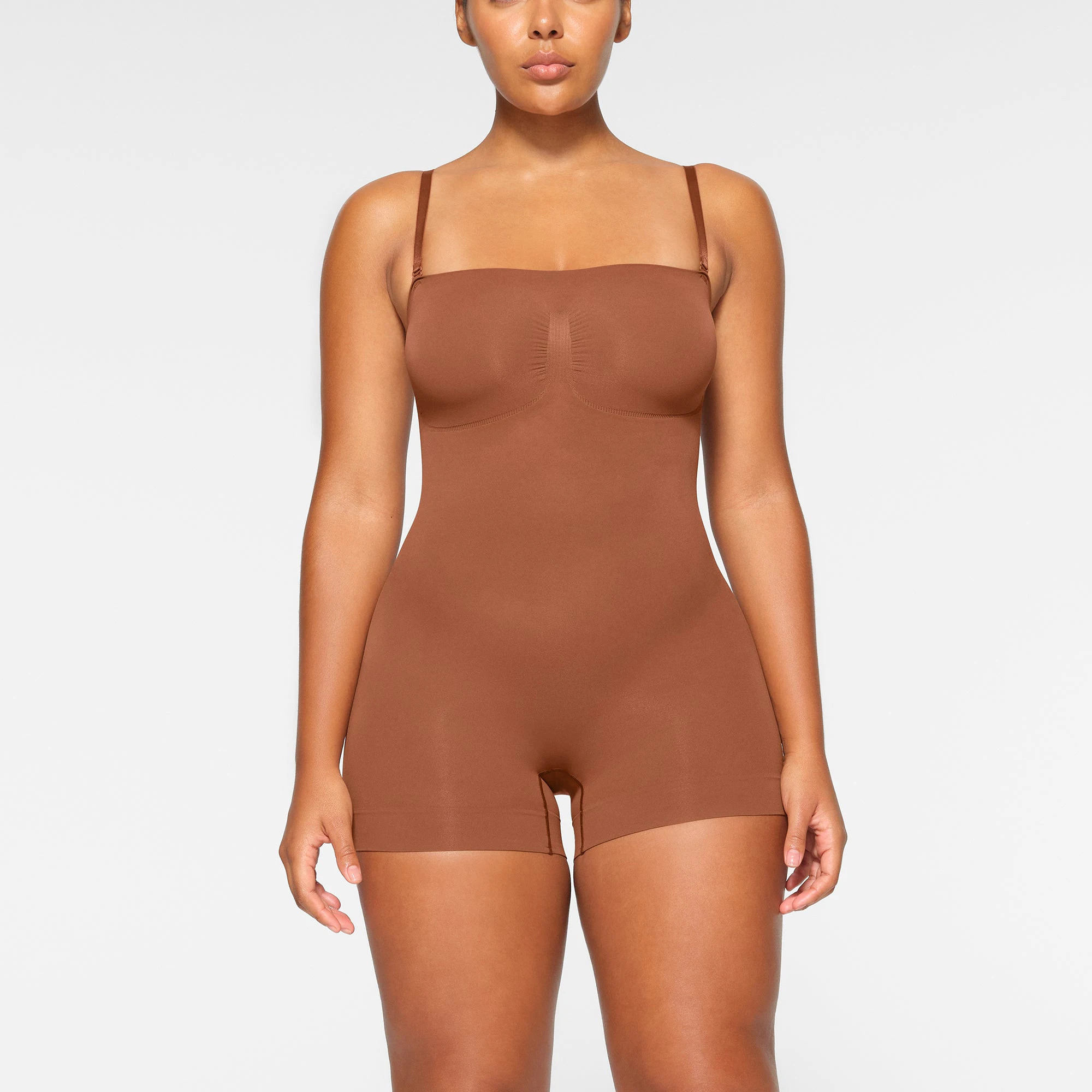 SEAMLESS SCULPT STRAPLESS MID THIGH BODYSUIT WORN BY A MODEL IN FRONT VIEW