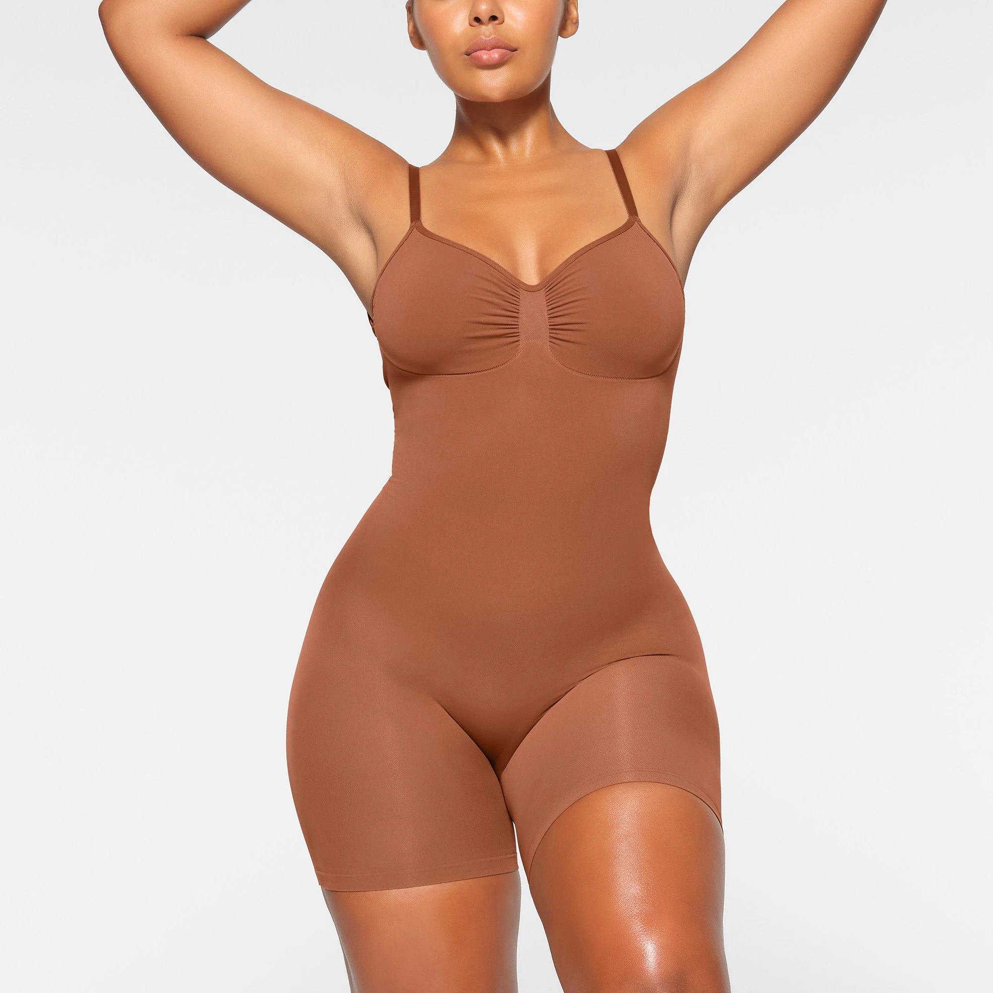 SEAMLESS SCULPT LOW BACK MID THIGH BODYSUIT WORN BY A MODEL IN FRONT VIEW | SEE: M, L, XL