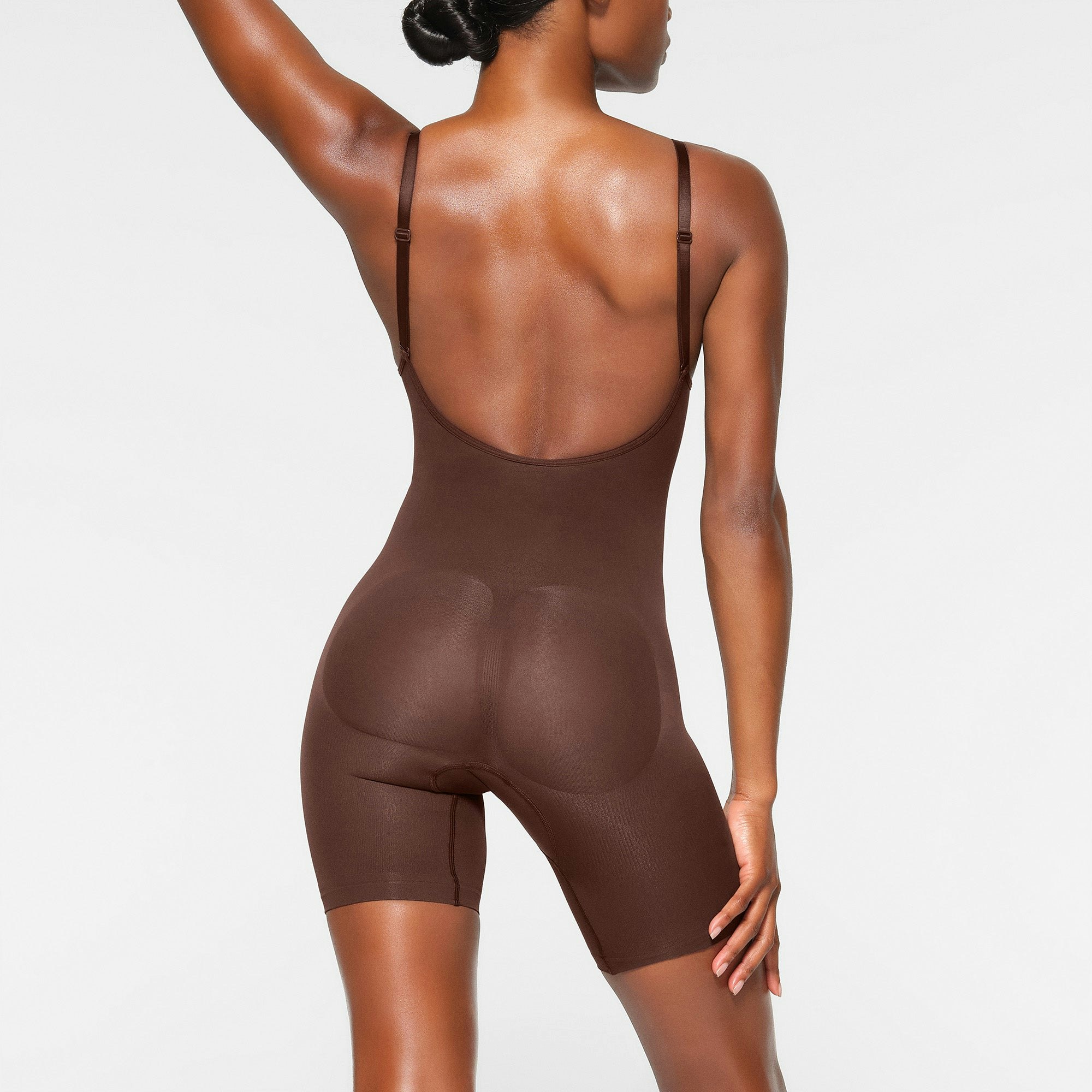 SEAMLESS SCULPT LOW BACK MID THIGH BODYSUIT WORN BY A MODEL IN SIDE VIEW