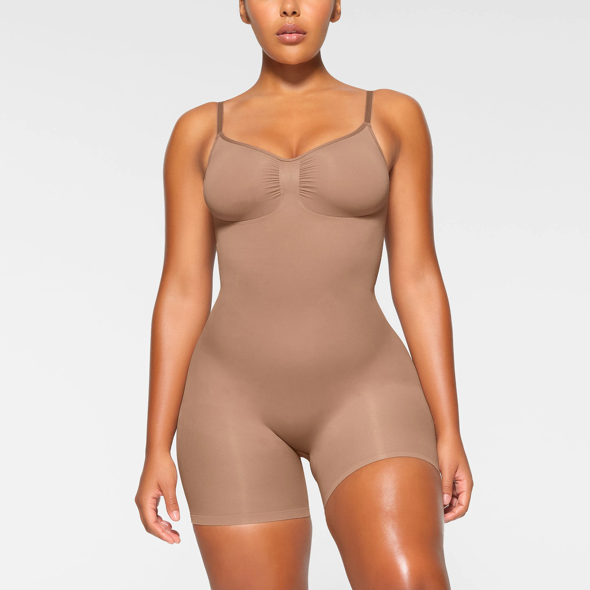 SEAMLESS SCULPT MID THIGH BODYSUIT WORN BY A MODEL IN FRONT VIEW, XL