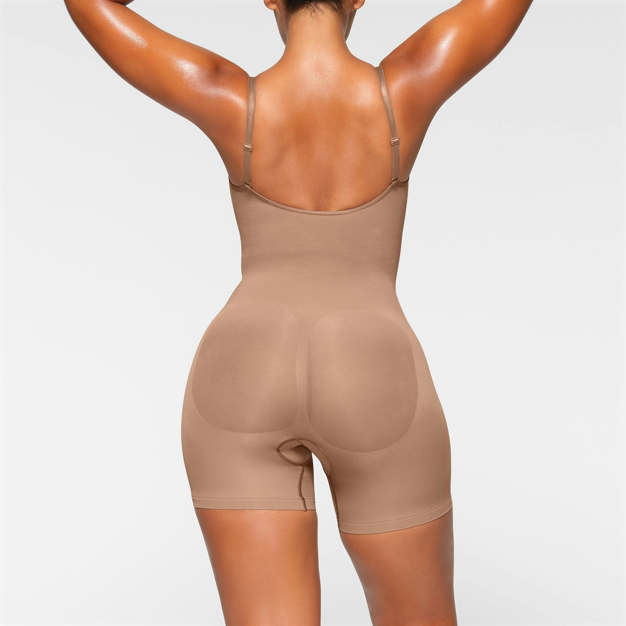 SEAMLESS SCULPT MID THIGH BODYSUIT ON A MODEL BACK VIEW