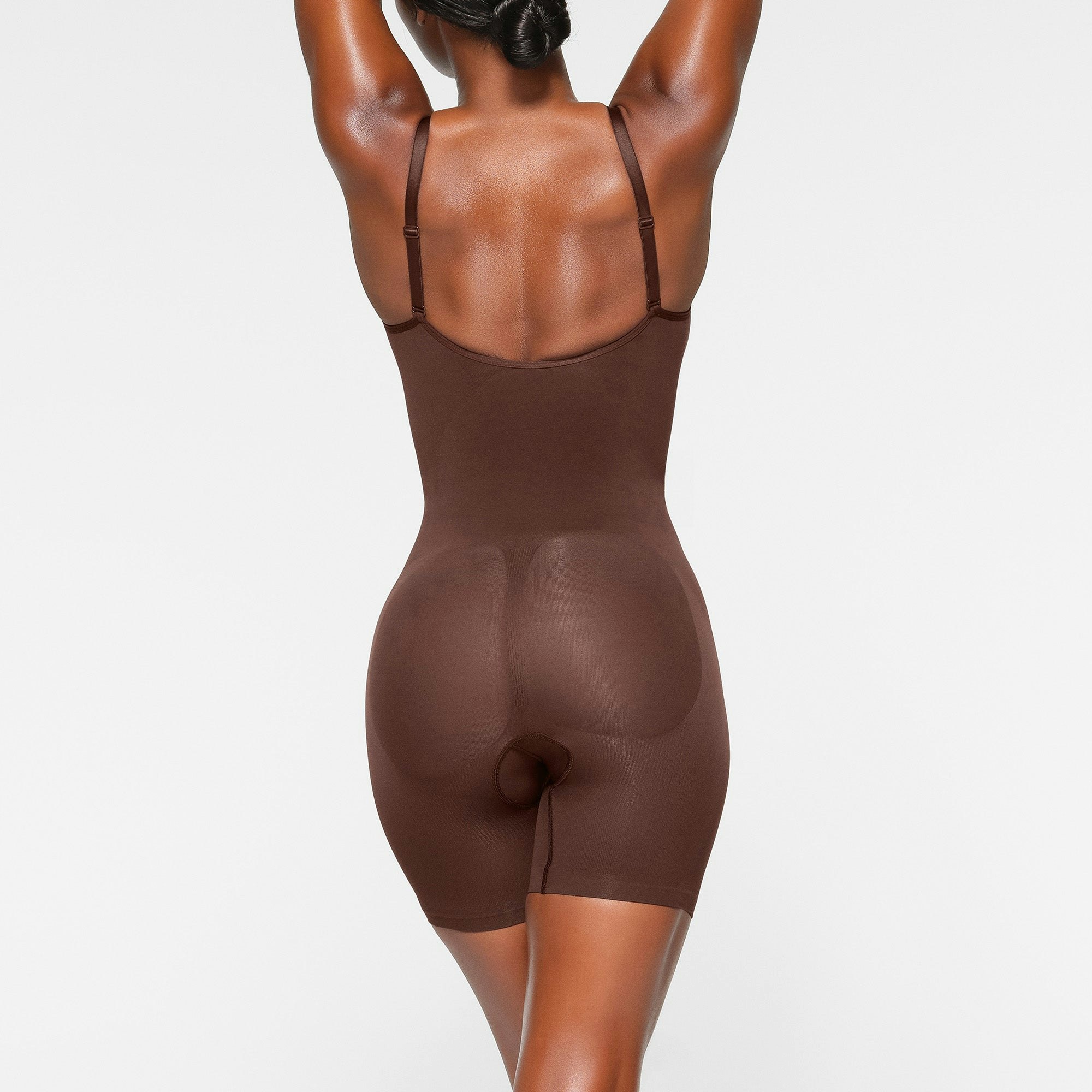 SEAMLESS SCULPT MID THIGH BODYSUIT ON A MODEL BACK VIEW