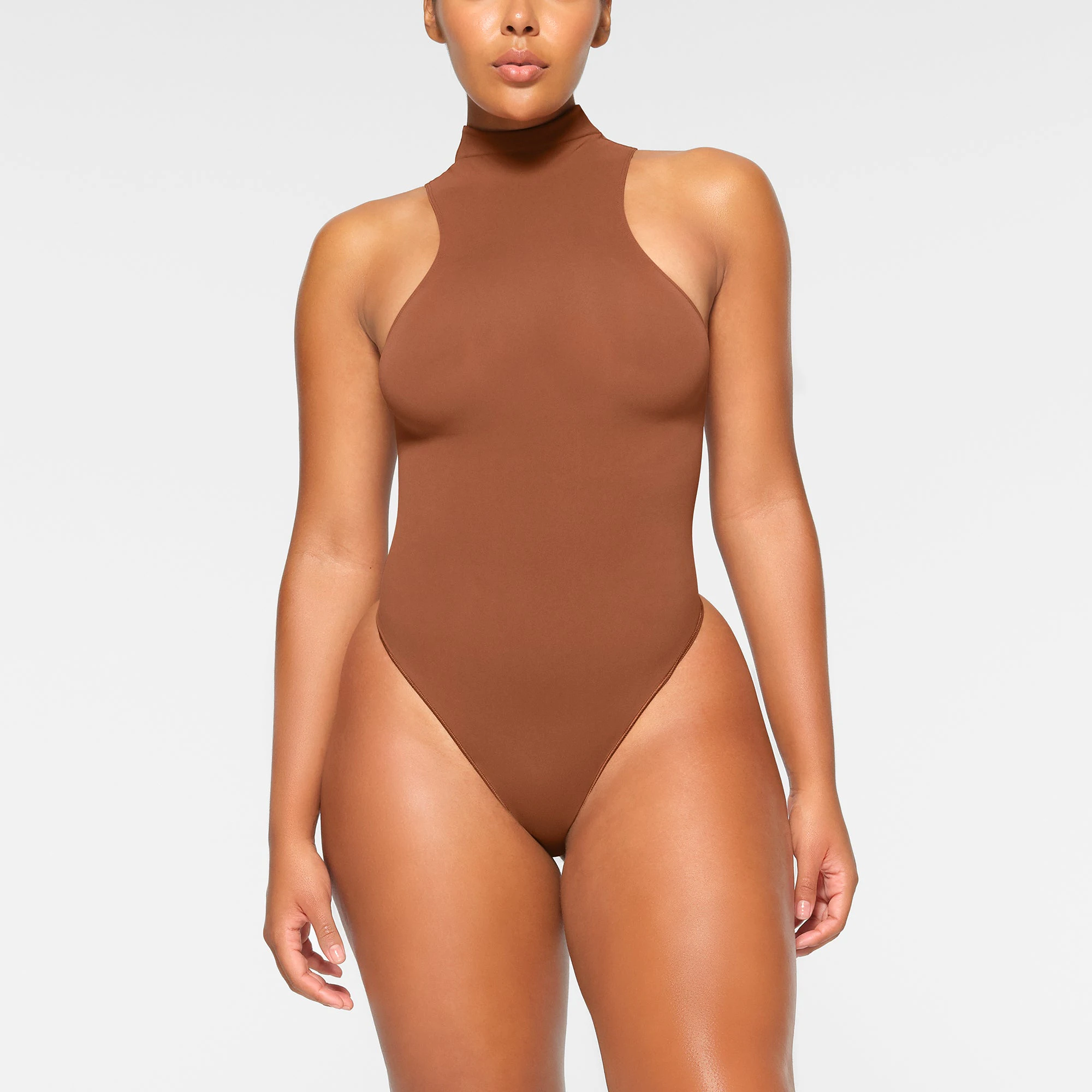 SEAMLESS SCULPT HIGH NECK THONG BODYSUIT WORN BY A MODEL IN FRONT VIEW | SEE: M, L, XL