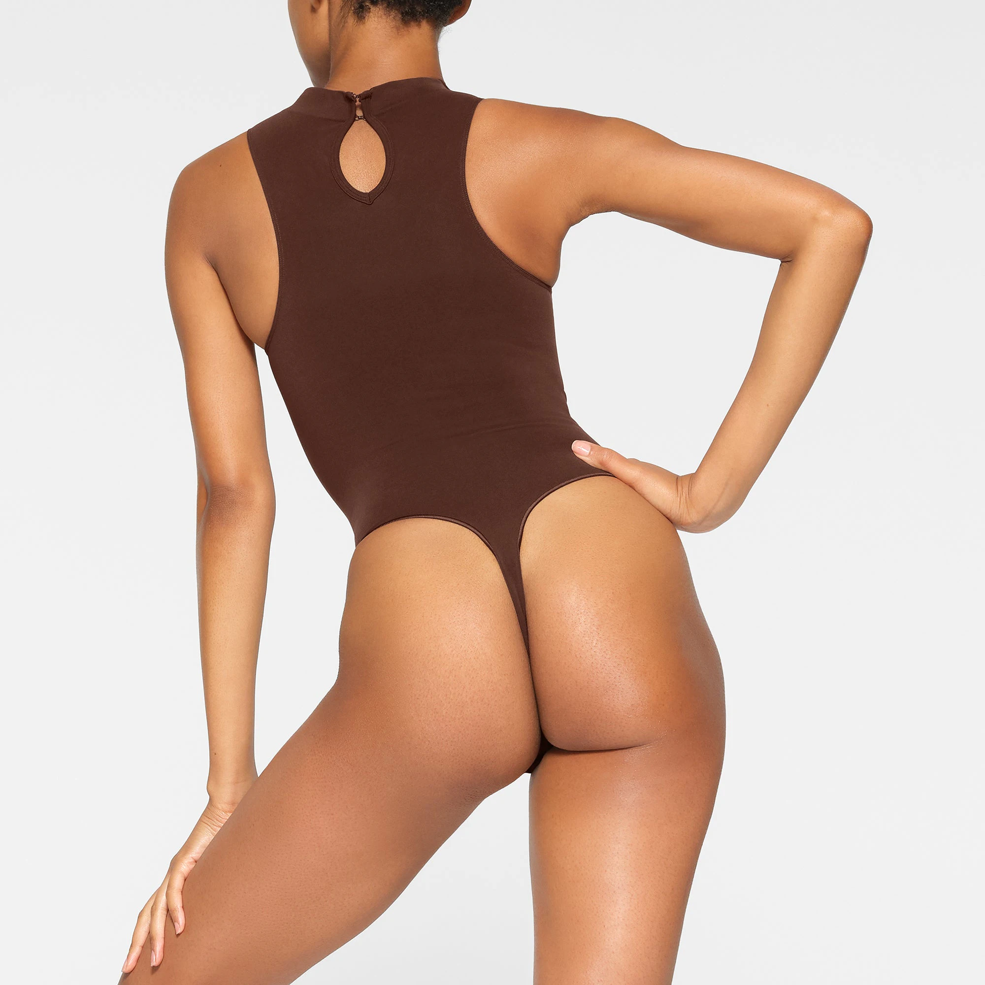 SEAMLESS SCULPT HIGH NECK THONG BODYSUIT WORN BY A MODEL IN BACK VIEW