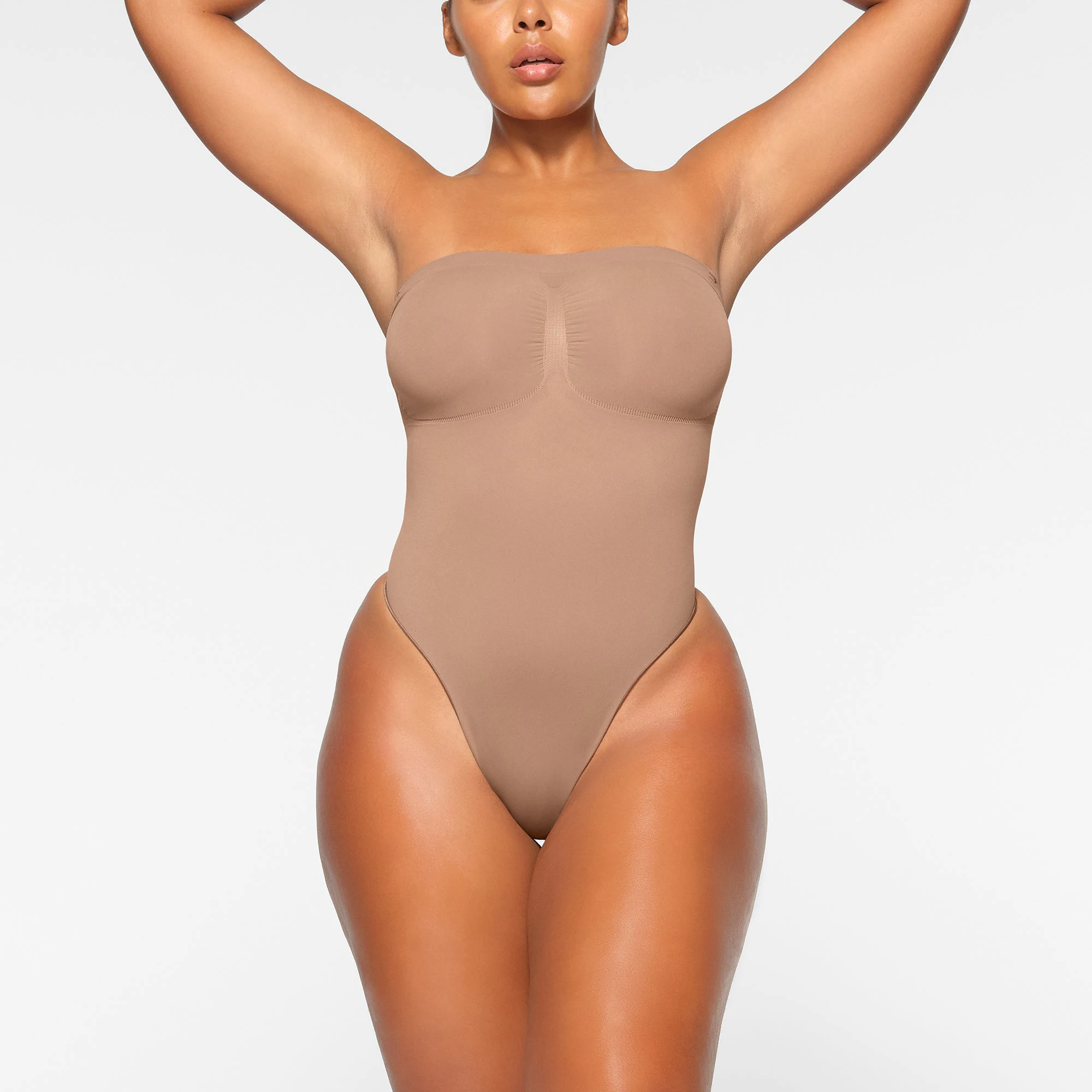 SEAMLESS SCULPT STRAPLESS THONG BODYSUIT WORN BY A MODEL IN FRONT VIEW, XL