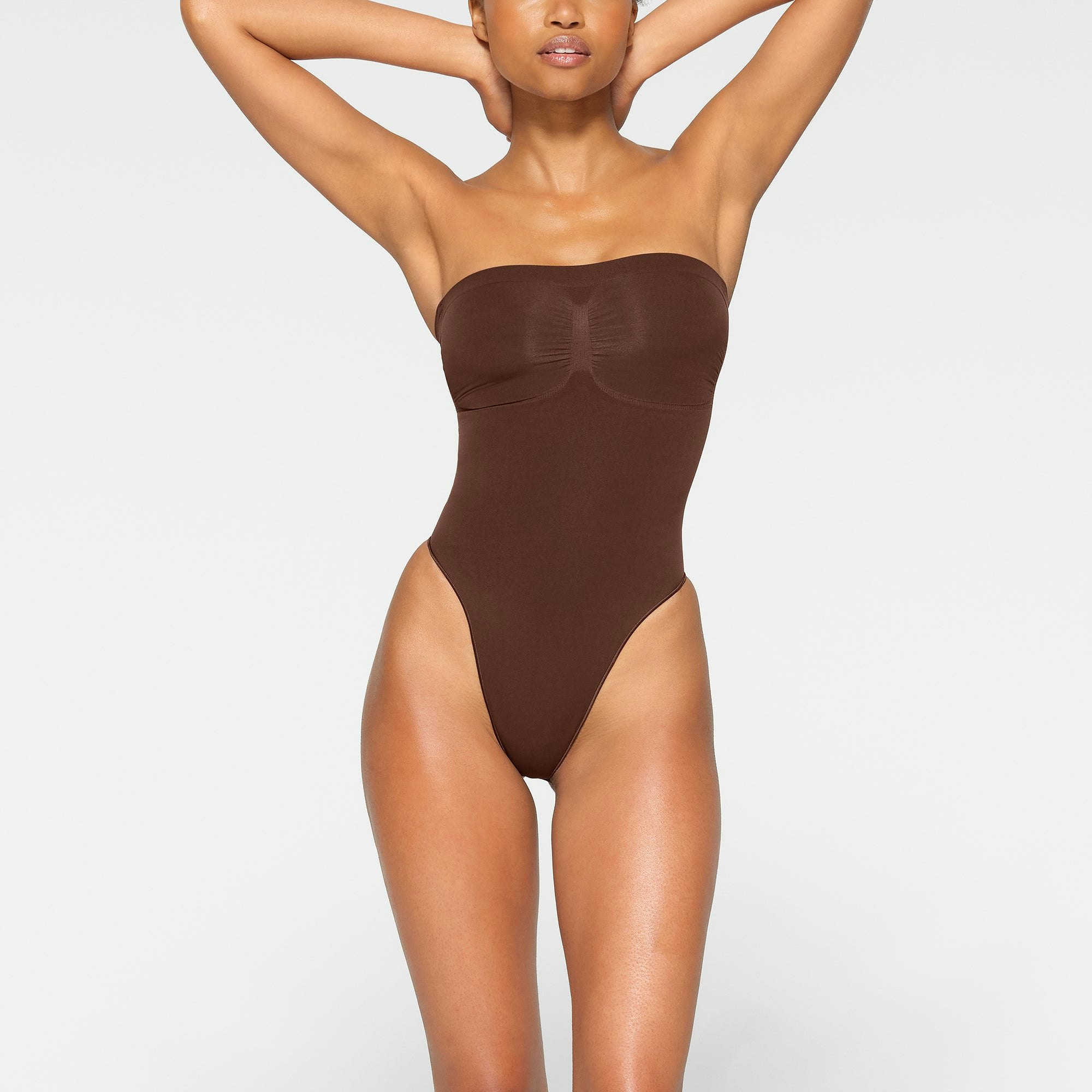 SEAMLESS SCULPT STRAPLESS THONG BODYSUIT WORN BY A MODEL IN FRONT VIEW | SEE: XXS, XS, S