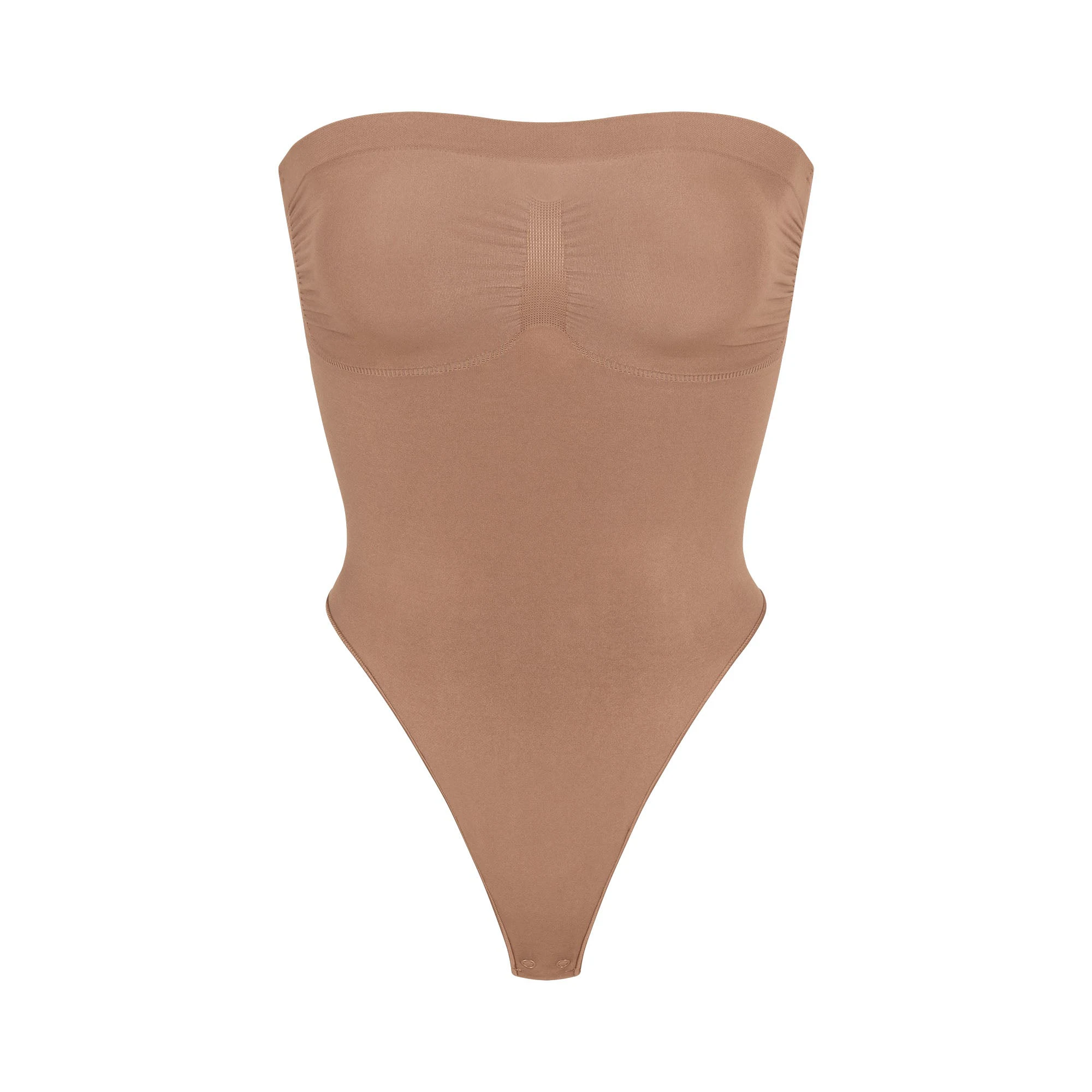 SEAMLESS SCULPT STRAPLESS THONG BODYSUIT | SIENNA (SHAPEWEAR BODYSUITS) LAYS FLAT ON A WHITE BACKGROUND | FLT