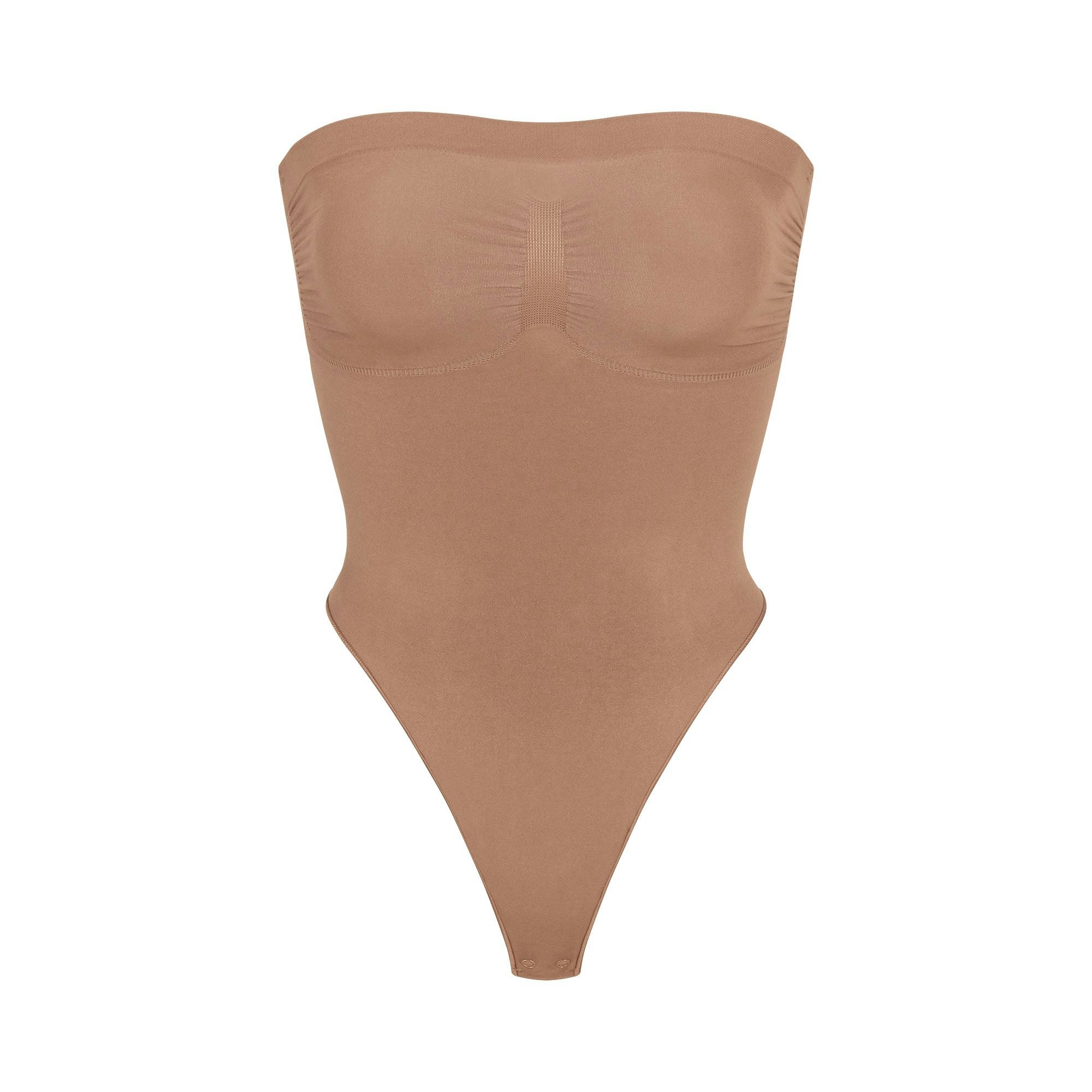 SEAMLESS SCULPT STRAPLESS THONG BODYSUIT | SIENNA (SHAPEWEAR BODYSUITS) LAYS FLAT ON A WHITE BACKGROUND | FLT